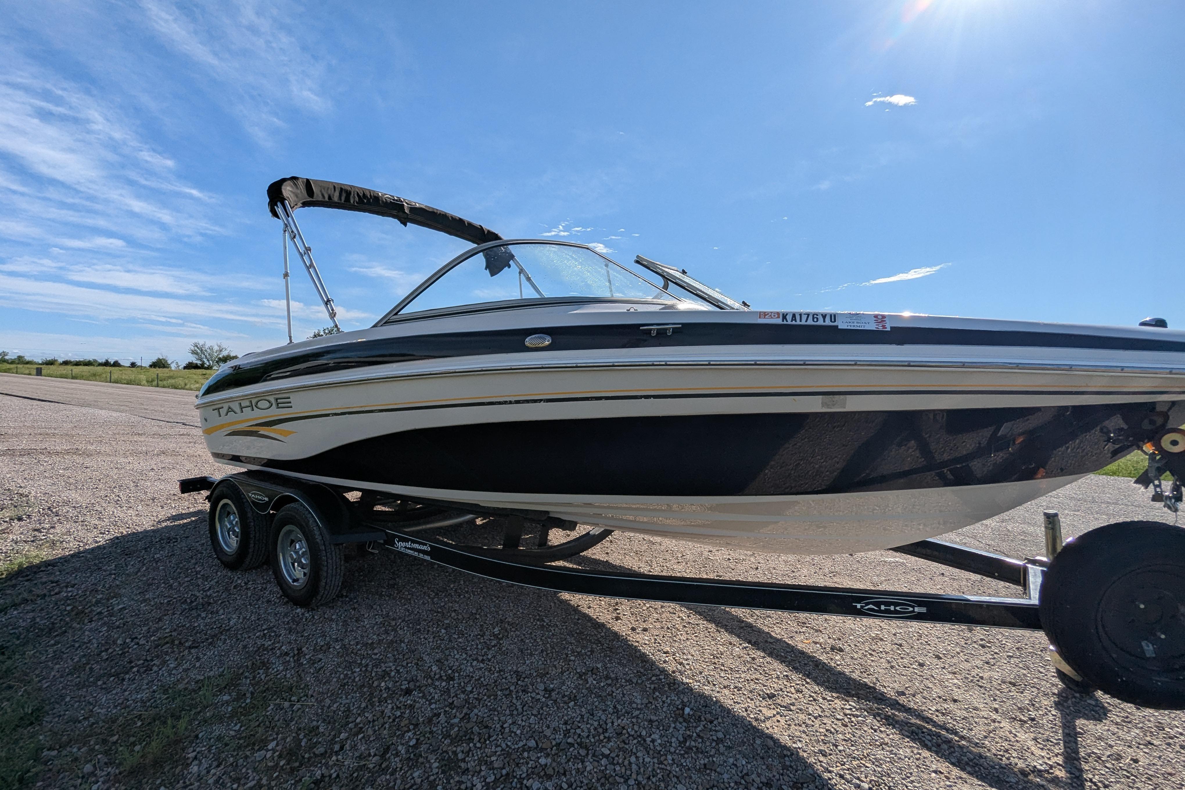 2006 Tahoe Q6 Sport boat on trailer under clear blue sky.