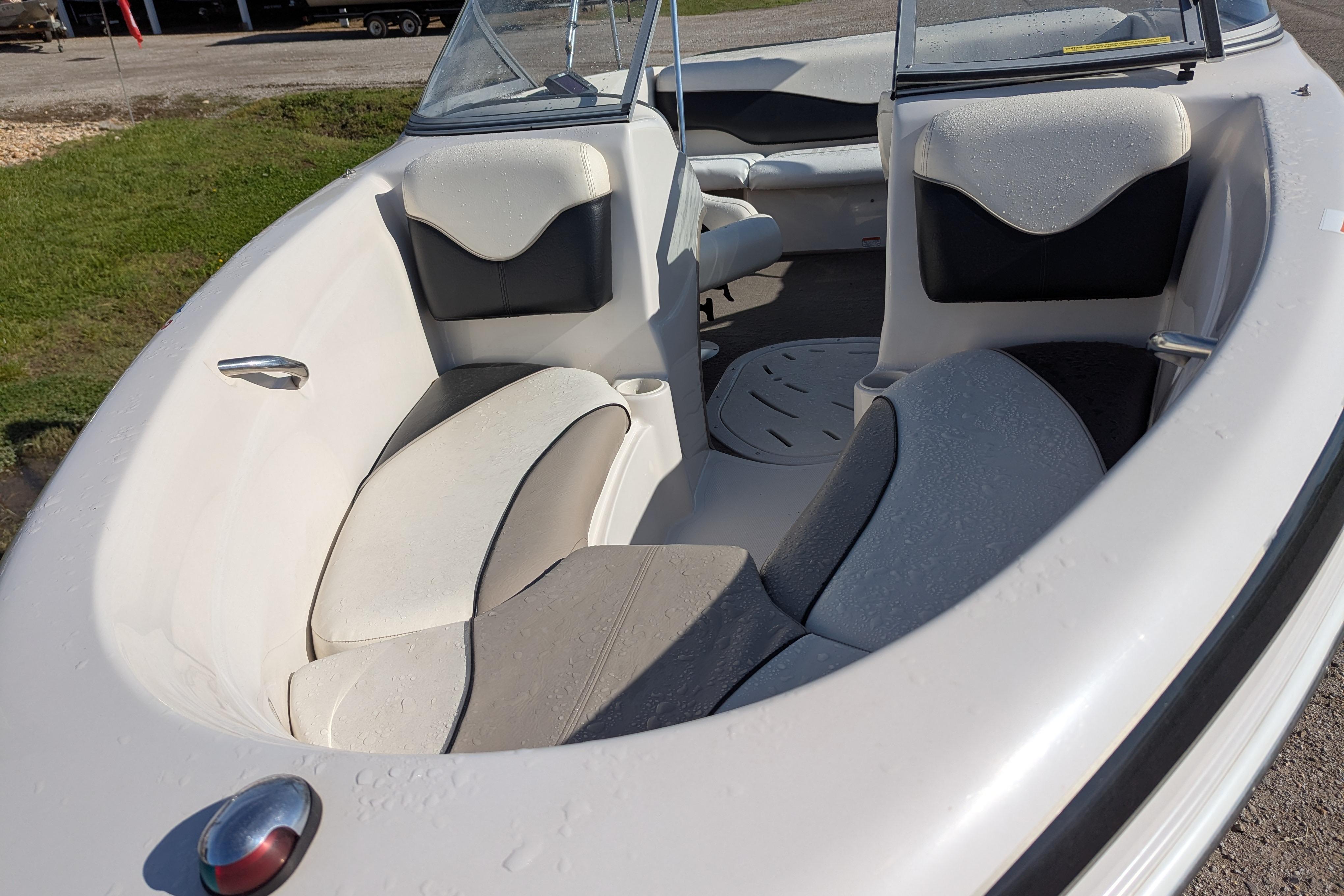2006 Tahoe Q6 Sport boat interior with cushioned seating and windshield.