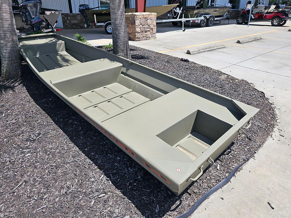 2025 Tracker Grizzly 14 Jon boat displayed outdoors on mulch near a parking lot.