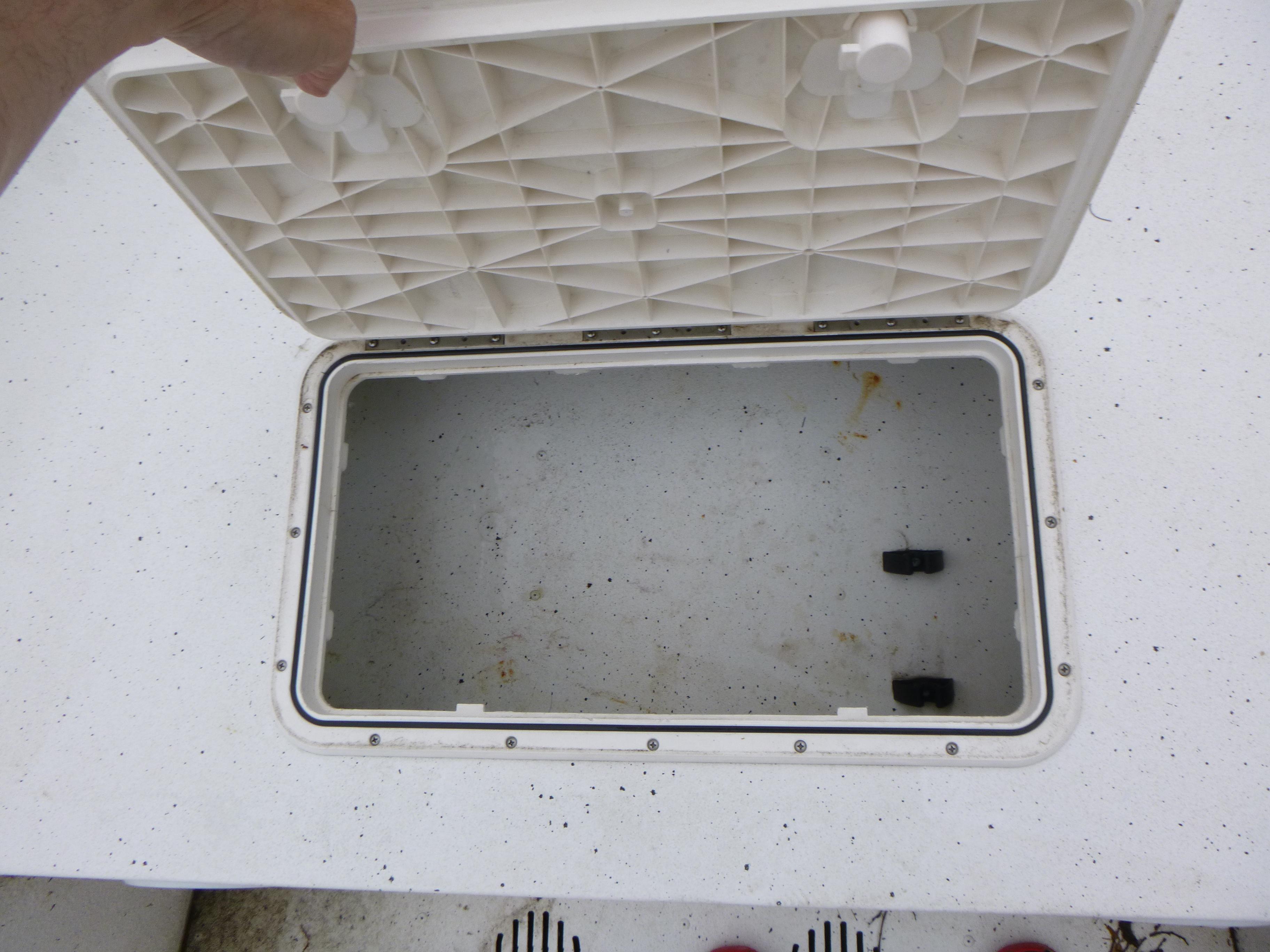 Open storage compartment on 2017 G3 Bay 18 DLX boat, showing interior space.