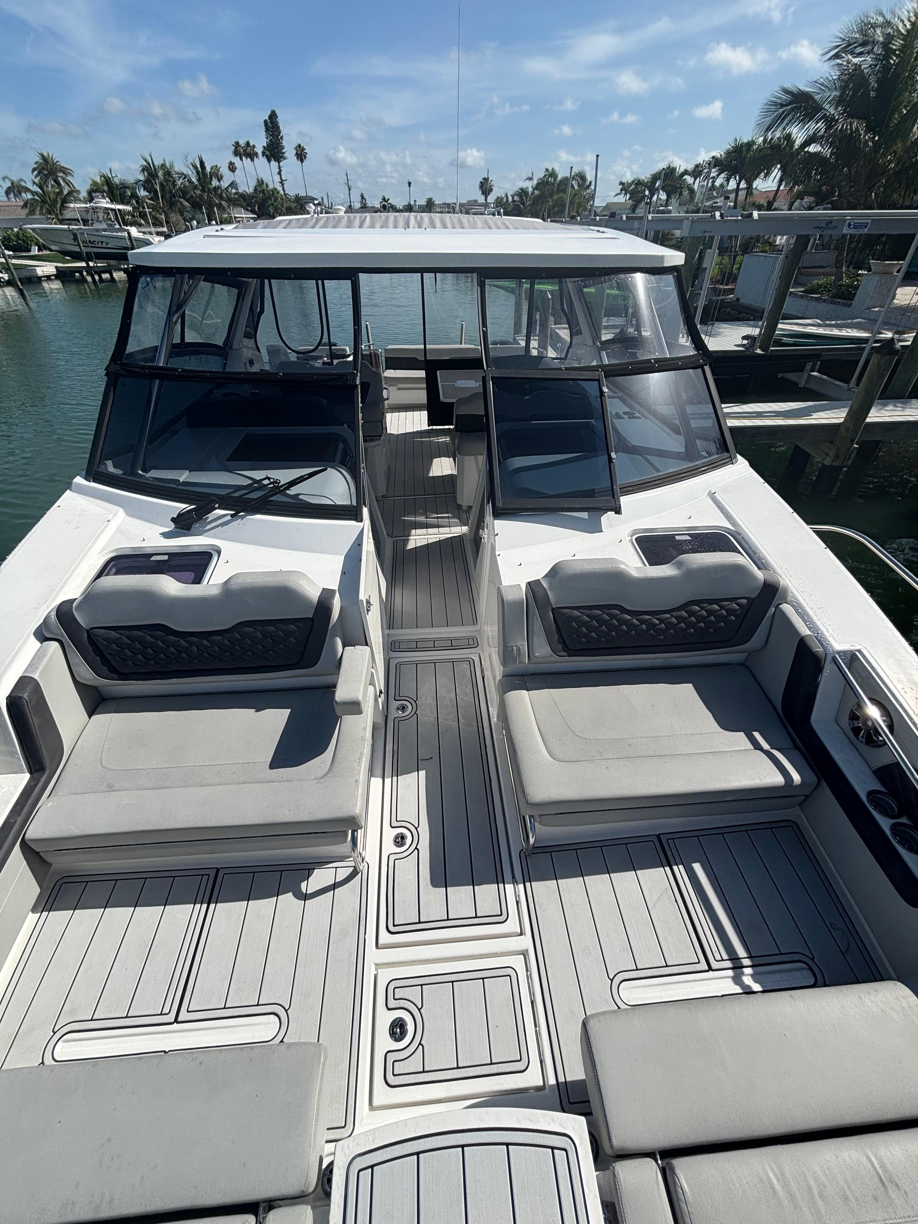 Aquila-36 Sport 2018-Namaste FL-US-2018 Aquila 36 Sport boat with spacious seating and sleek design on a sunny day.-9848040 | Thumbnail