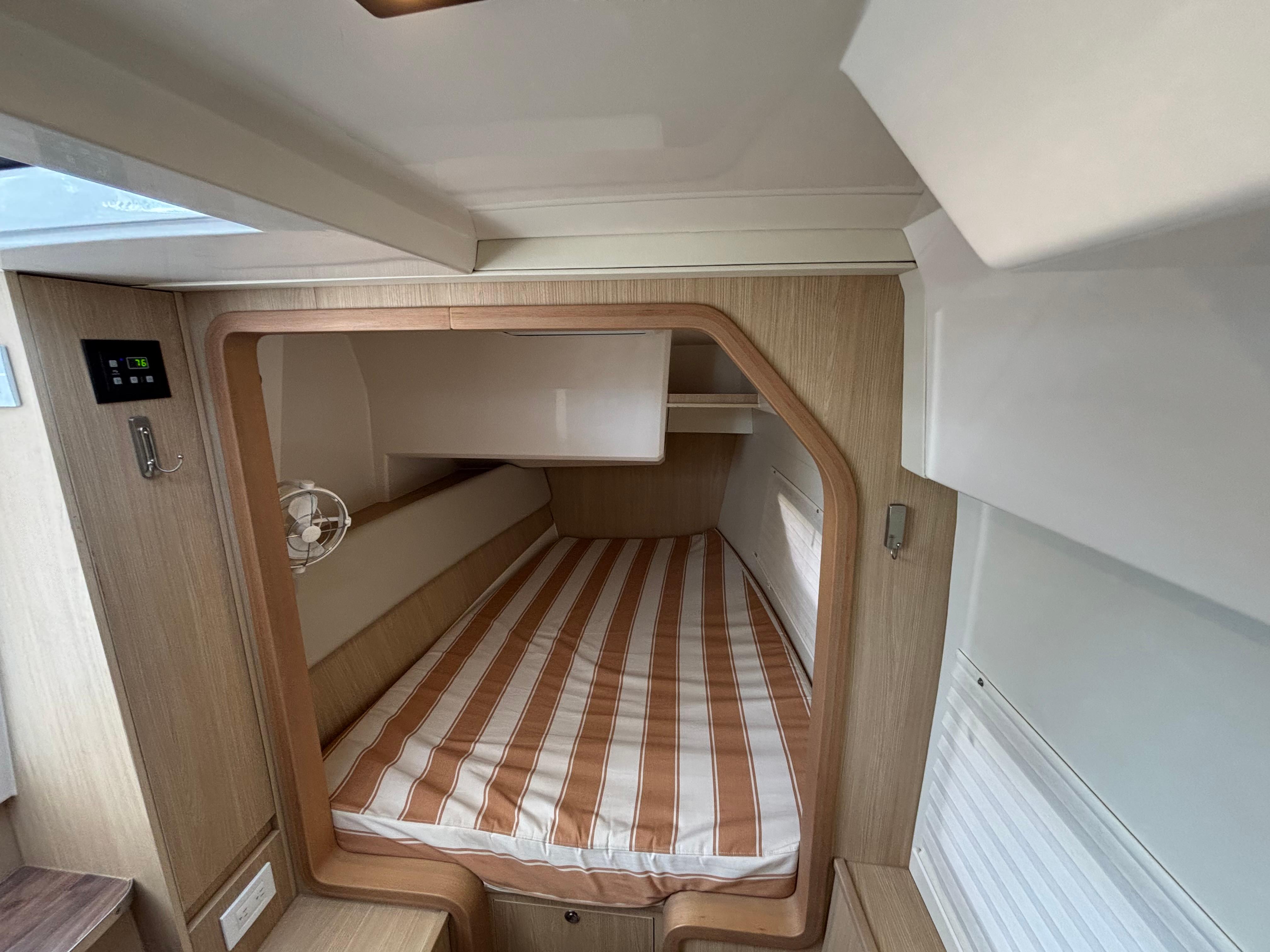 Aquila-36 Sport 2018-Namaste FL-US-Cabin interior of 2018 Aquila 36 Sport with striped bedding and wooden accents.-9848040 | Thumbnail