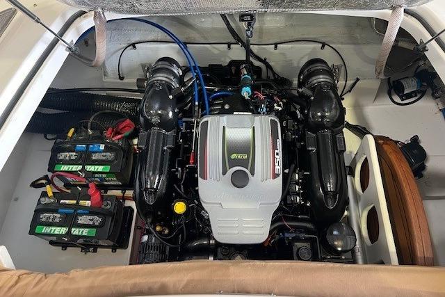 Engine compartment of a 2011 Chris-Craft Launch 22 boat, featuring a powerful 350 engine.