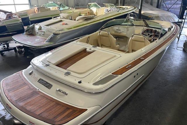 2011 Chris-Craft Launch 22 boat with elegant wood detailing in a showroom.