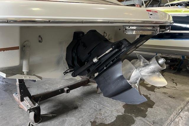 2011 Chris-Craft Launch 22 boat propeller and stern view in a garage setting.