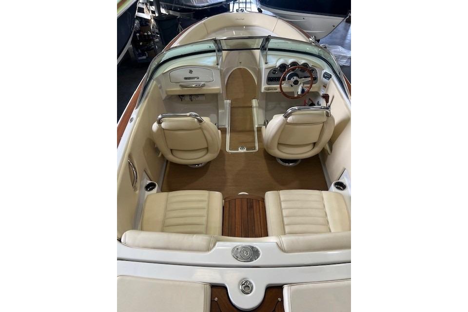 2011 Chris-Craft Launch 22 boat interior with beige seating and wooden accents.