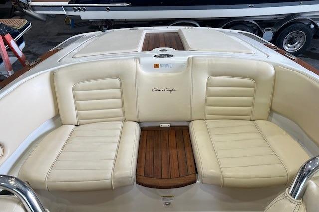 2011 Chris-Craft Launch 22 boat interior with cream leather seats and wooden accents.