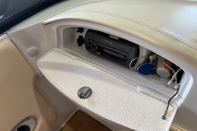 2011 Chris-Craft Launch 22 dashboard with stereo system and storage compartment.