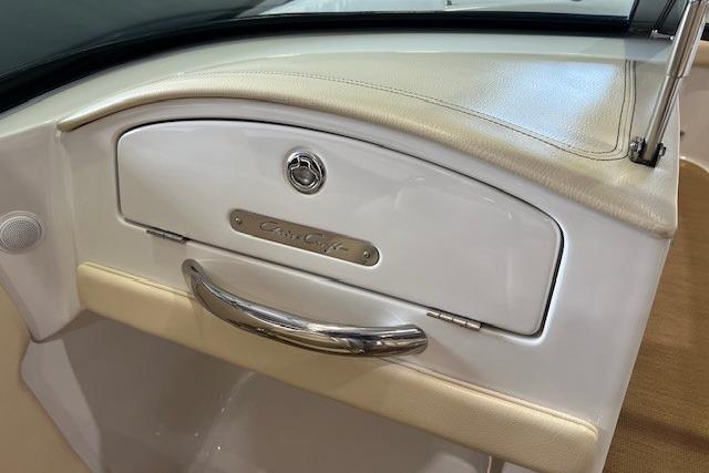 2011 Chris-Craft Launch 22 interior detail with elegant glove compartment and chrome handle.