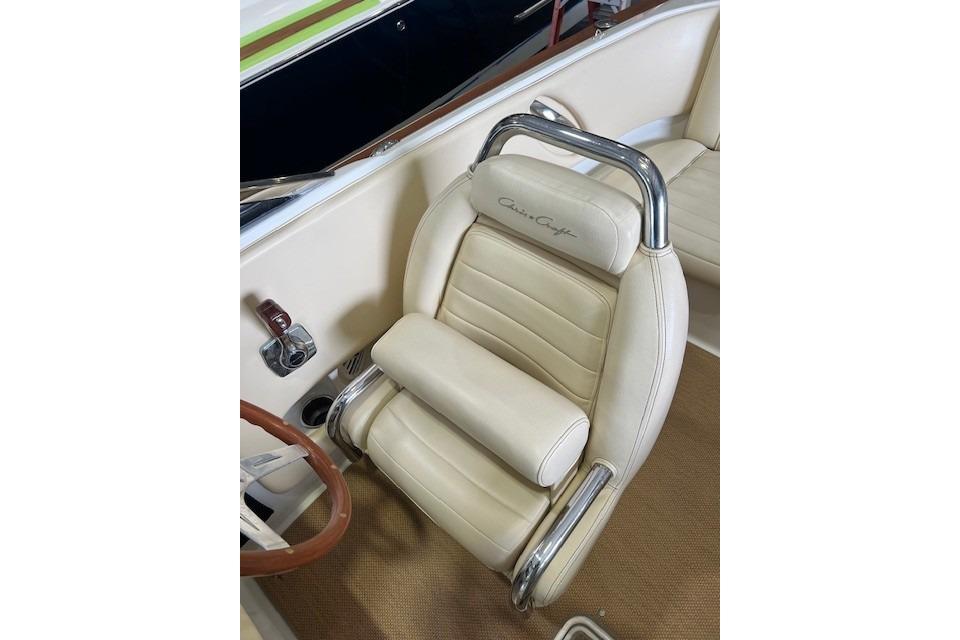 Luxurious interior of 2011 Chris-Craft Launch 22 boat with cream leather seat.