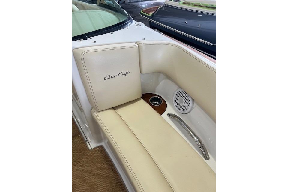 2011 Chris-Craft Launch 22 boat interior with beige seating and speaker detail.
