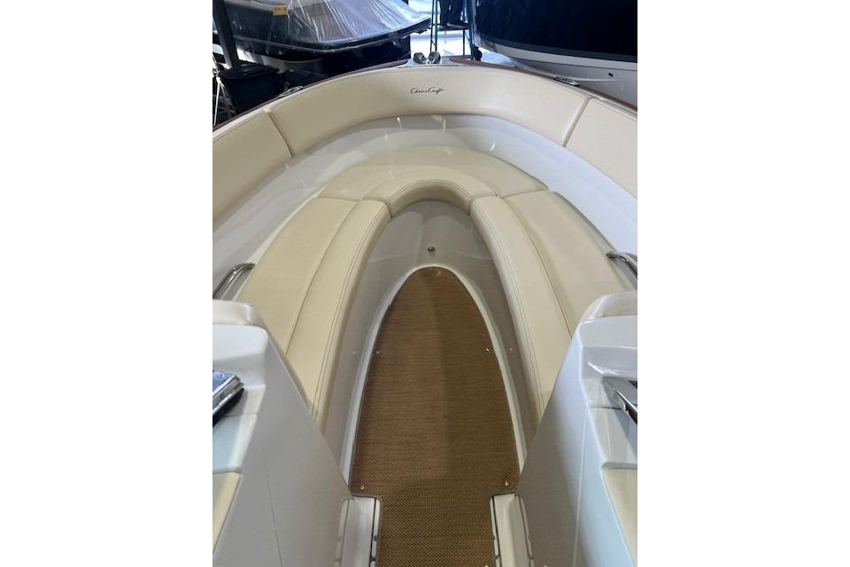 2011 Chris-Craft Launch 22 boat interior with beige seating and carpeted floor.