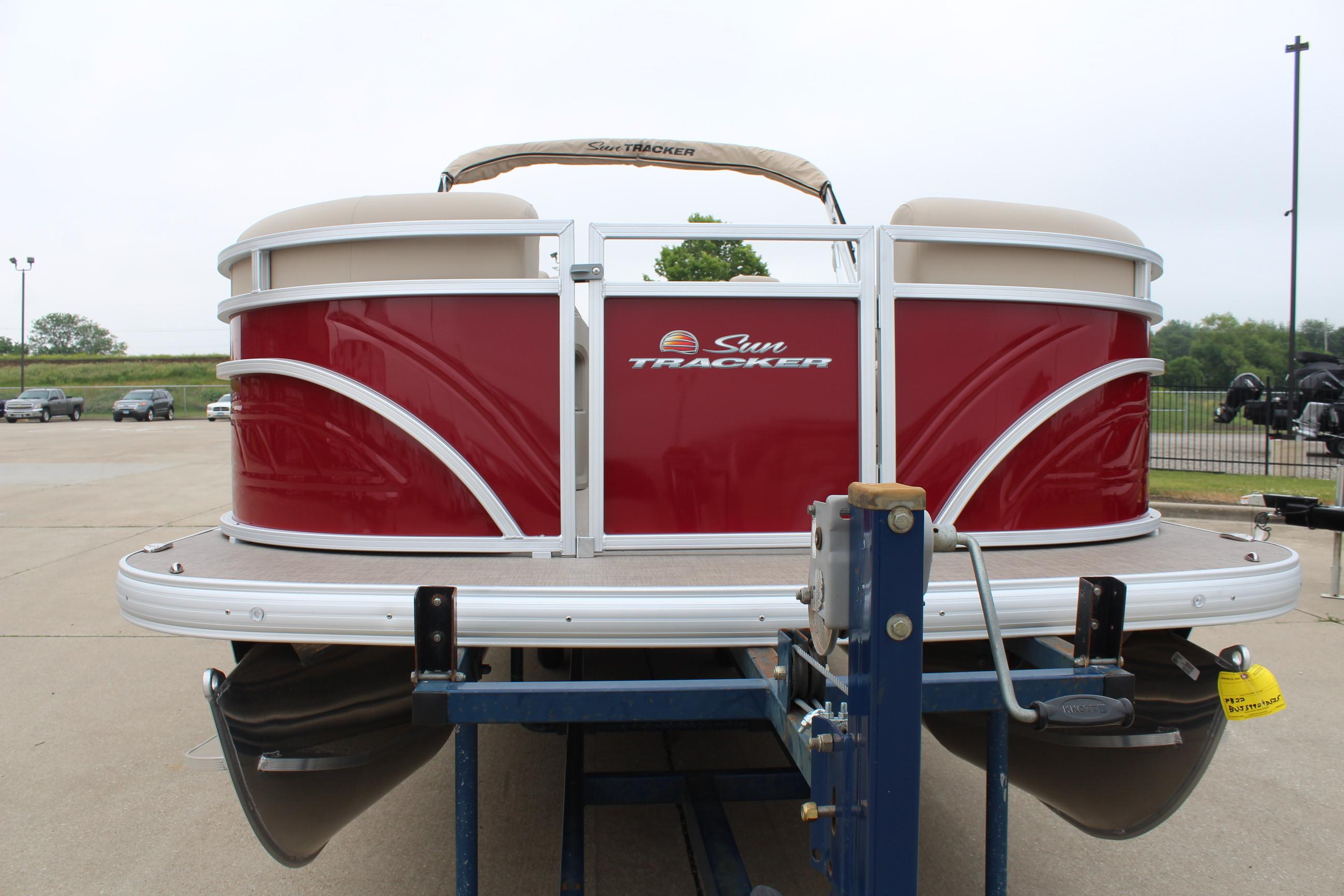 2025 Sun Tracker Party Barge 22 DLX pontoon boat on trailer, red exterior.