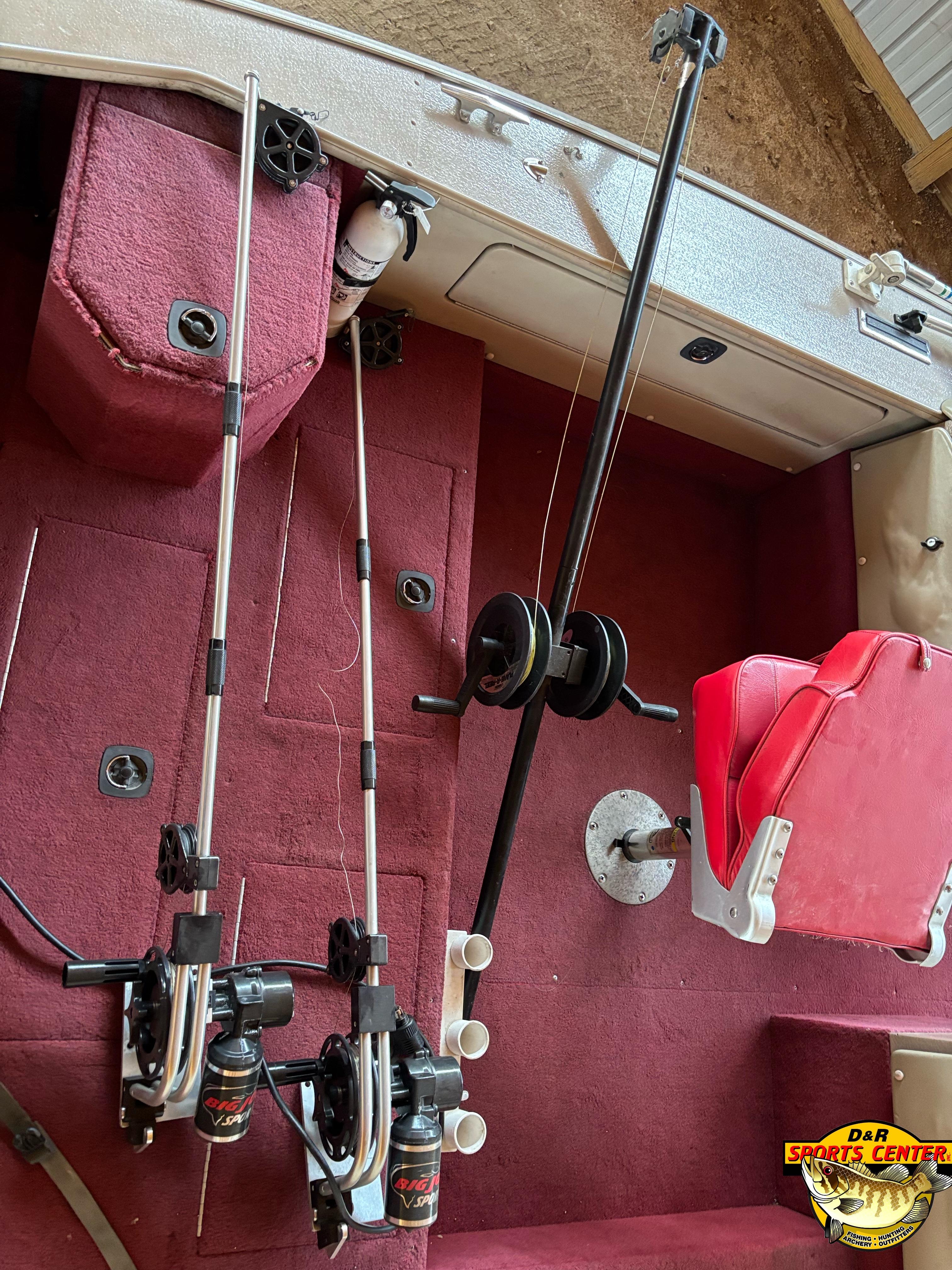 1997 Lund 1900 Pro-V LE boat interior with fishing rods and red seating.