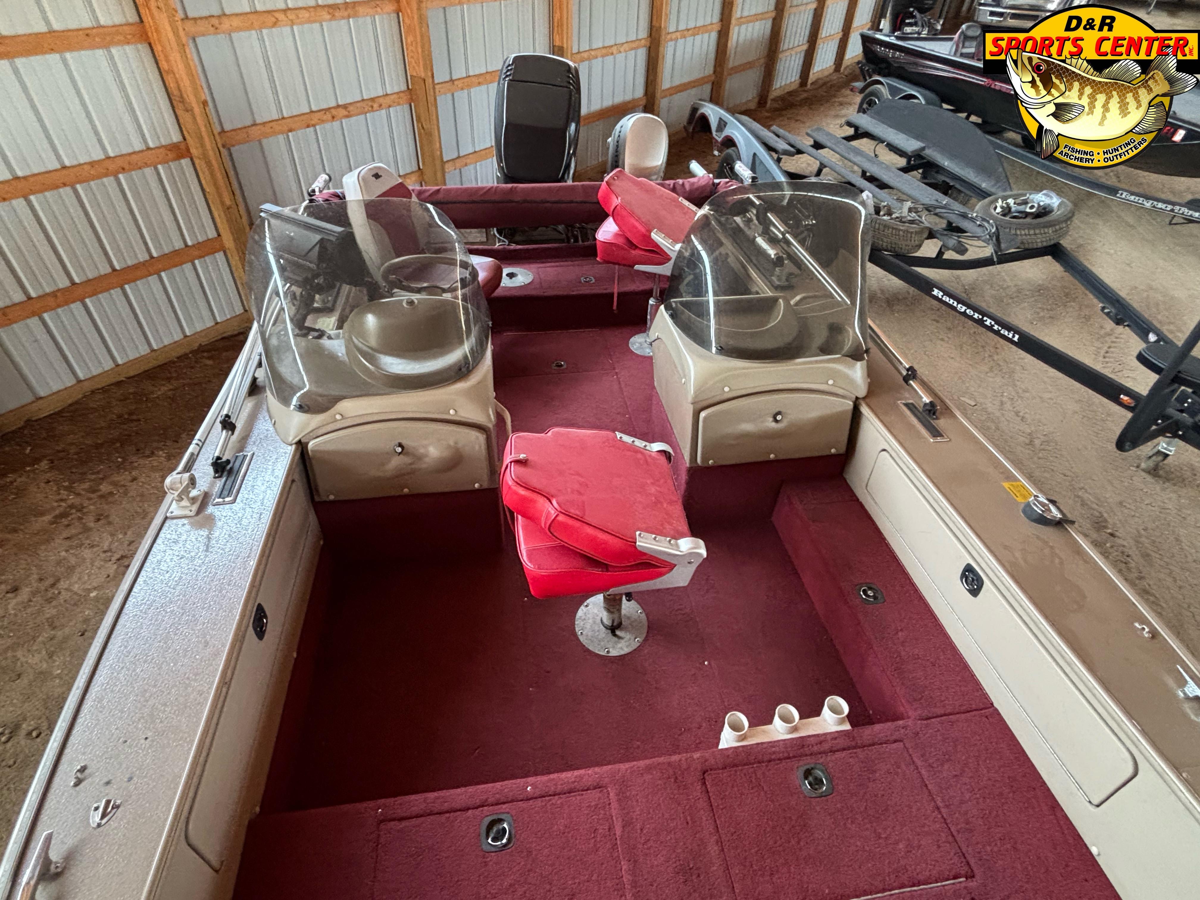 1997 Lund 1900 Pro-V LE boat interior with red seating and dual windshields in storage.
