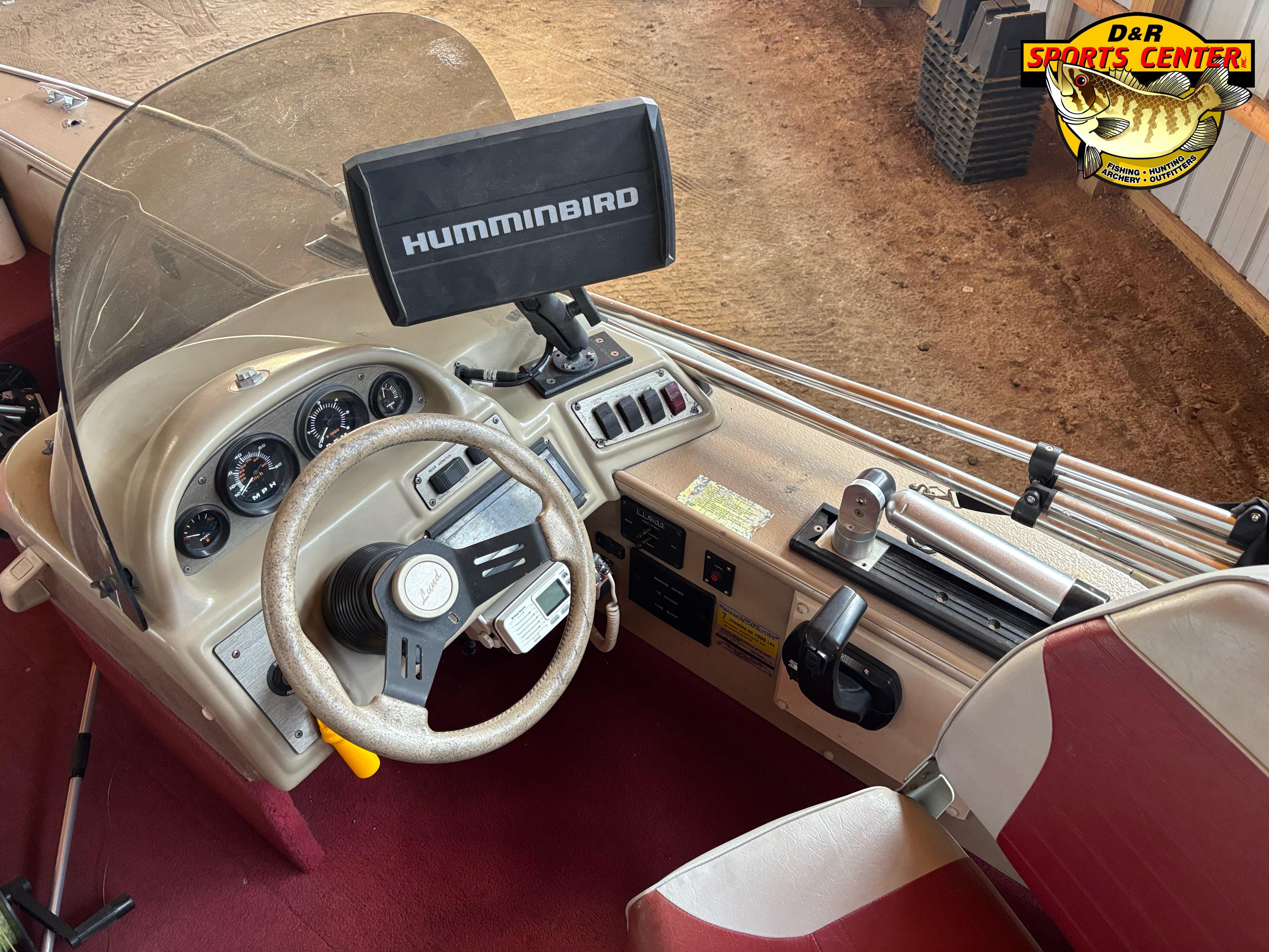 1997 Lund 1900 Pro-V LE boat dashboard with Humminbird fish finder and steering wheel.