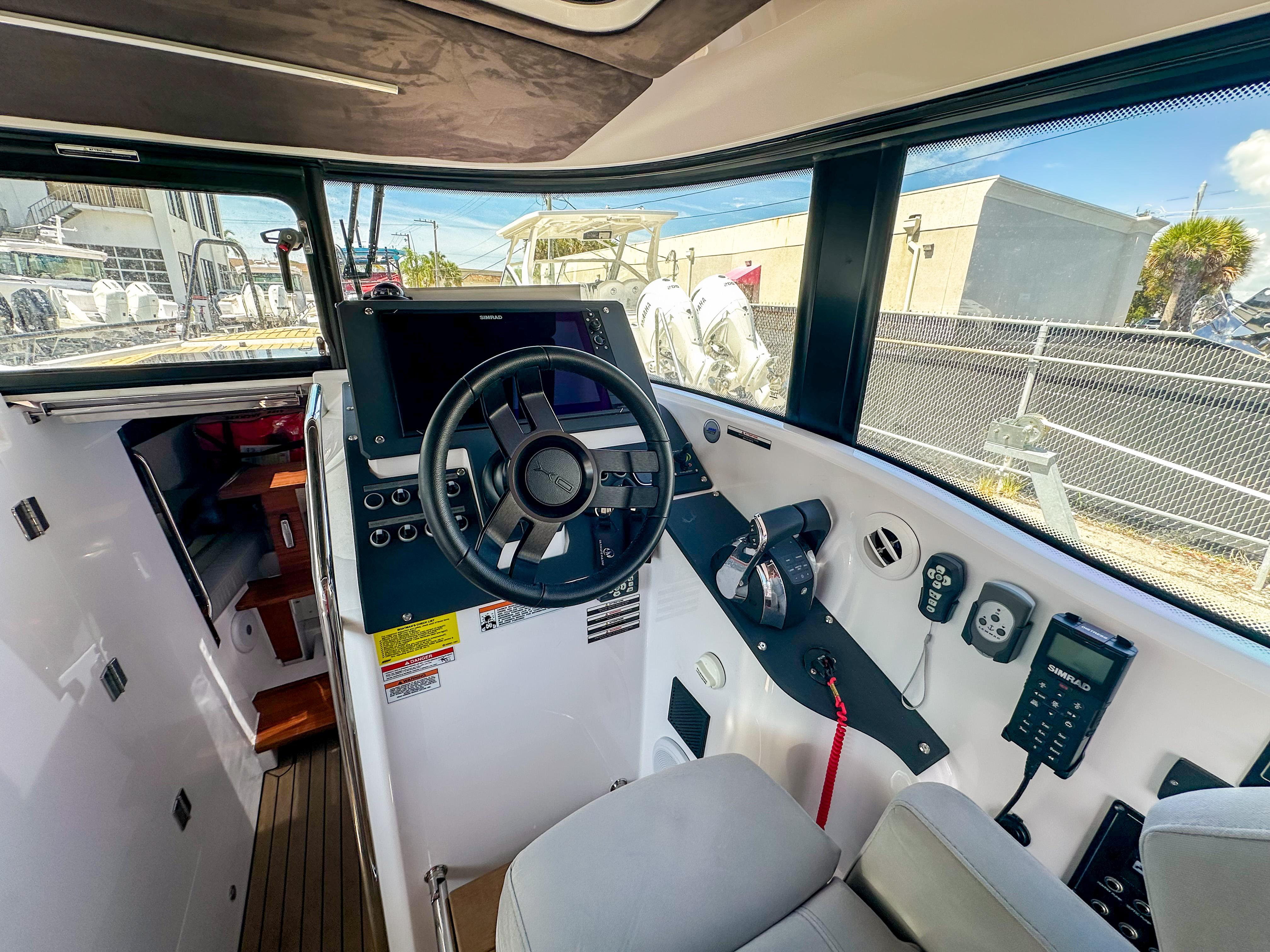 XO Boats-EXPLR 10 Sport Plus 2024 -FL-US-2024 XO Boats EXPLR 10 Sport Plus cockpit with modern controls and steering wheel.-9818089 | Thumbnail
