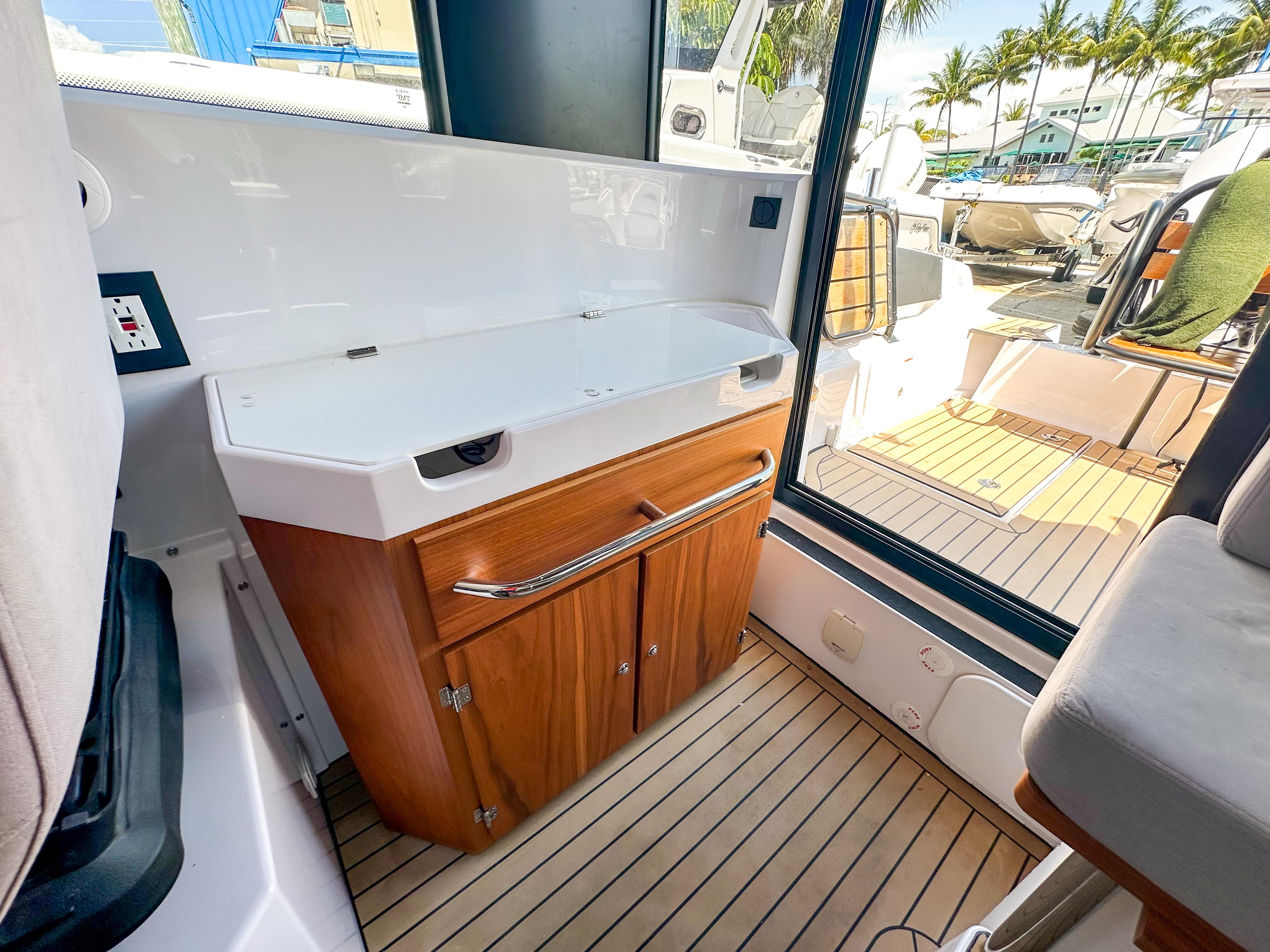XO Boats-EXPLR 10 Sport Plus 2024 -FL-US-2024 XO Boats EXPLR 10 Sport Plus interior with wooden cabinetry and sleek design.-9818089 | Thumbnail