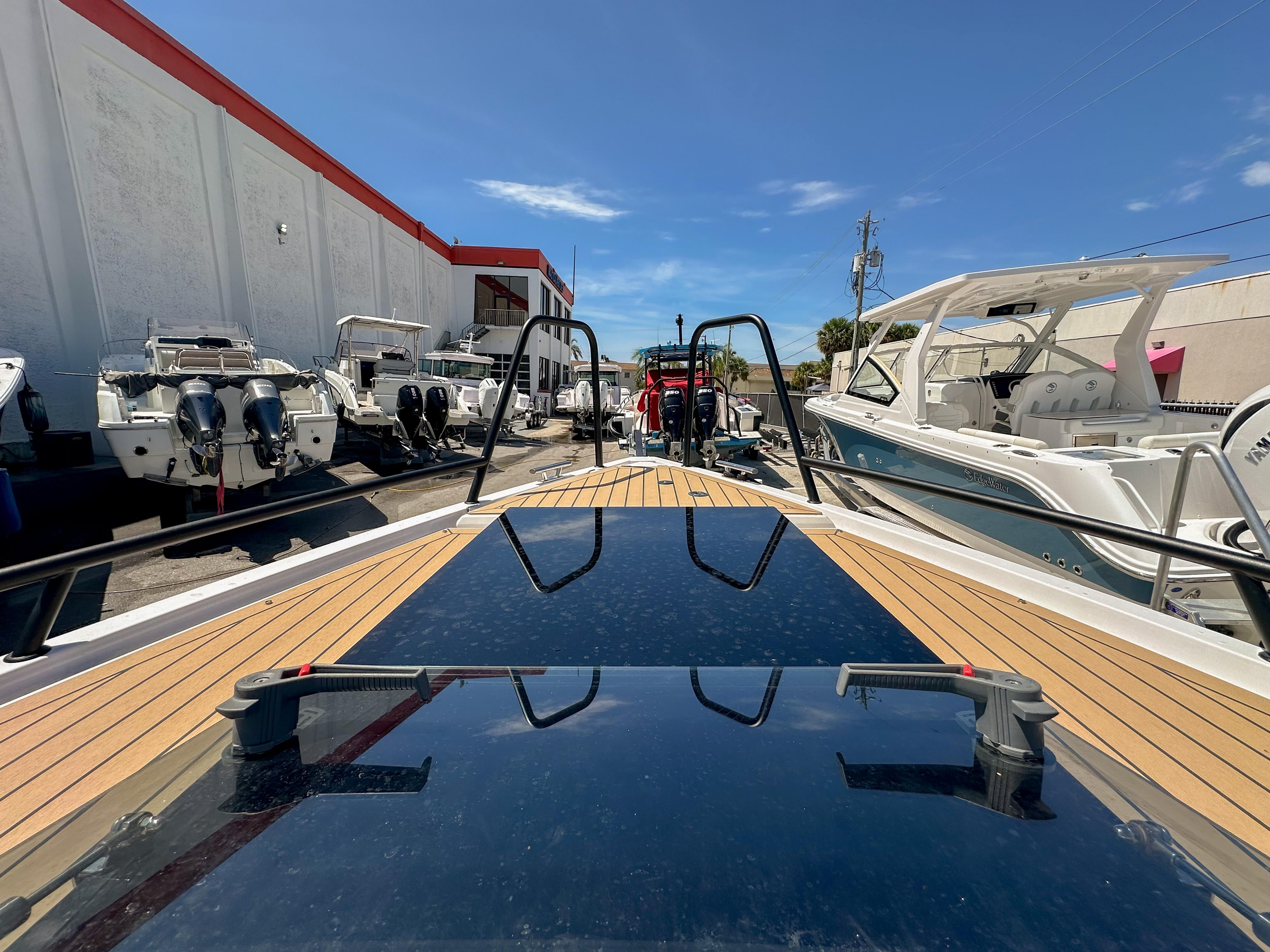 XO Boats-EXPLR 10 Sport Plus 2024 -FL-US-2024 XO Boats EXPLR 10 Sport Plus on display at a marina, surrounded by other boats.-9818089 | Thumbnail