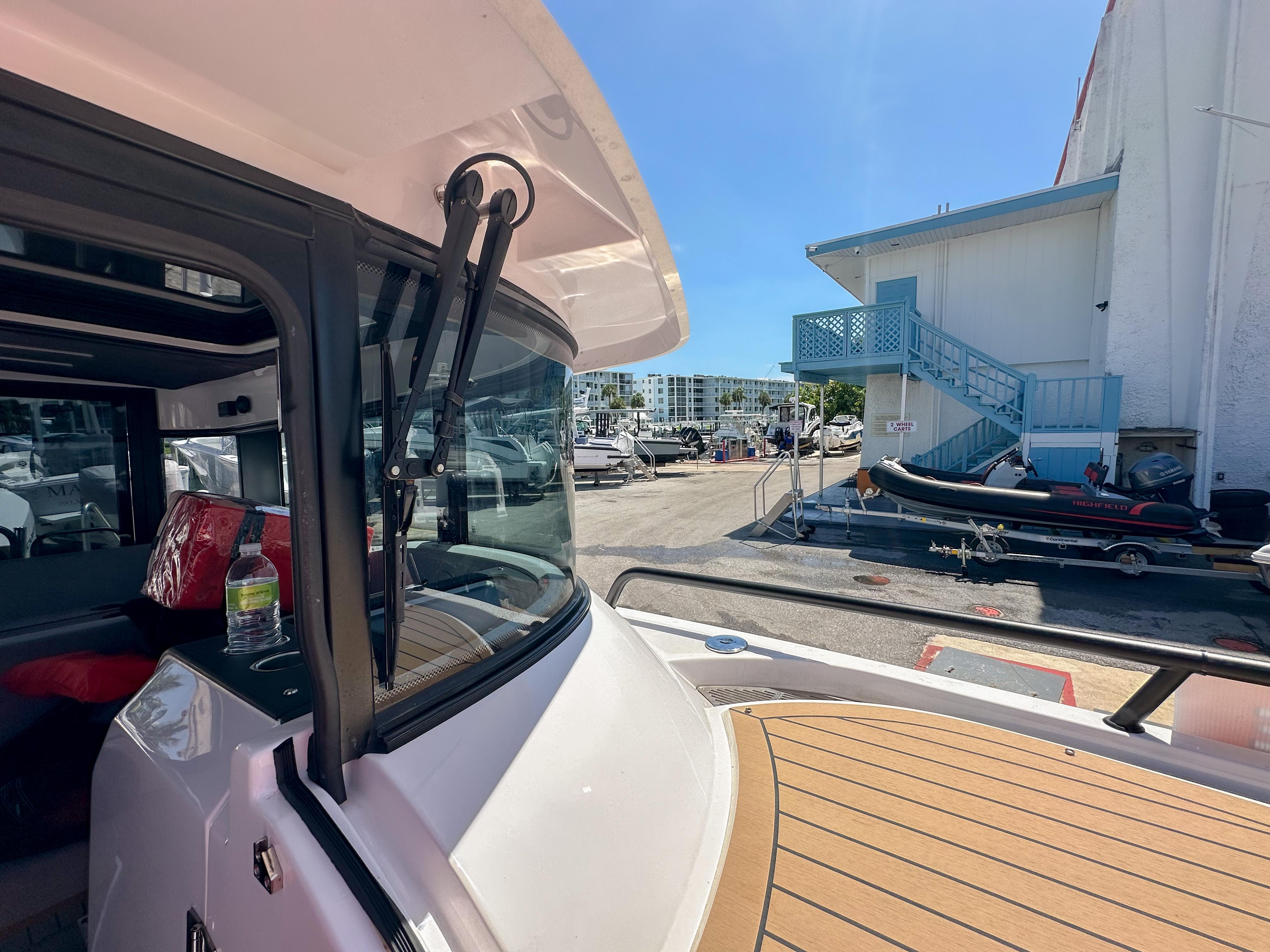 XO Boats-EXPLR 10 Sport Plus 2024 -FL-US-2024 XO Boats EXPLR 10 Sport Plus docked near a marina building.-9818089 | Thumbnail