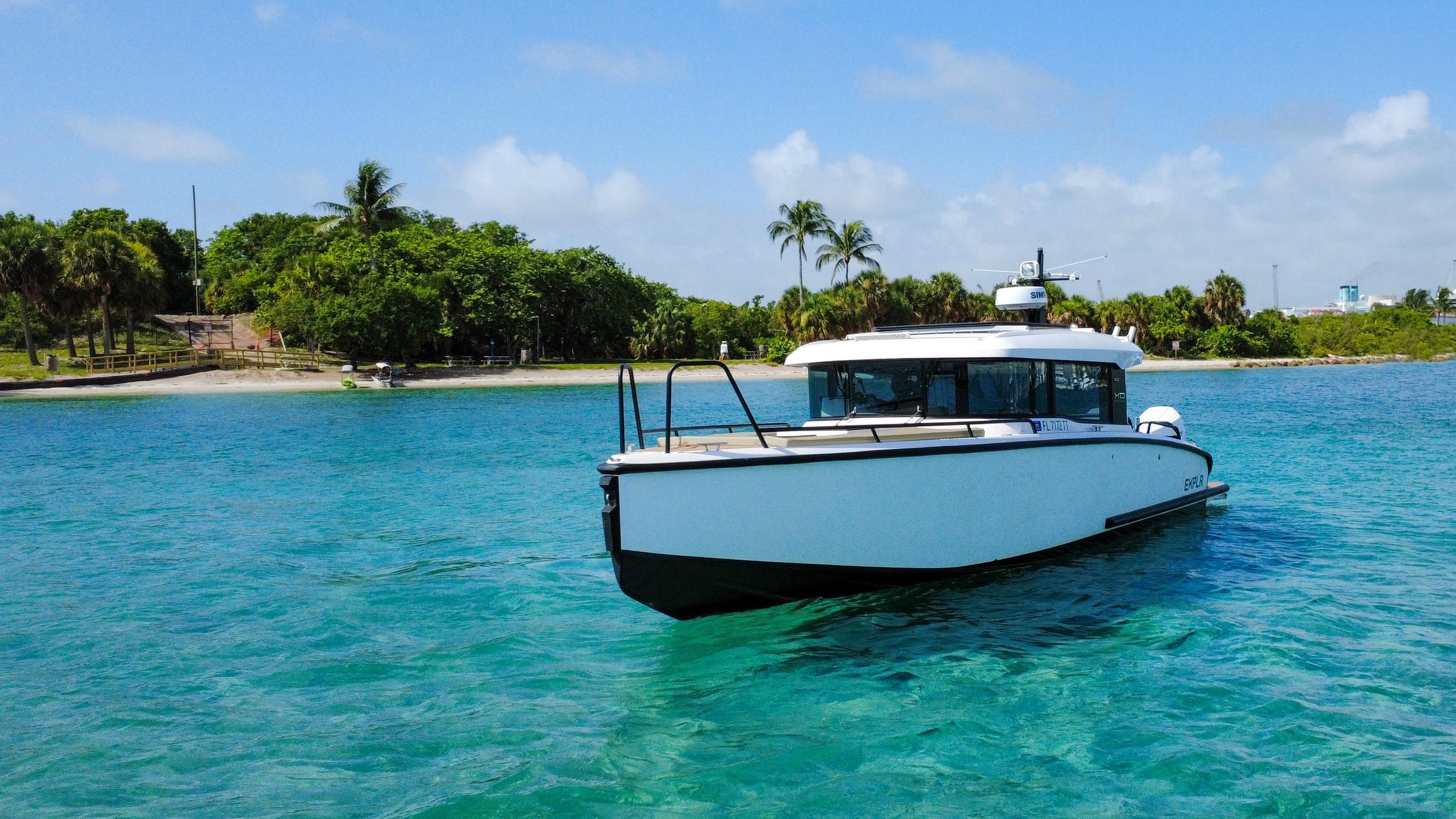XO Boats-XO Boats EXPLR 10S Plus 2024 -FL-US-2024 XO Boats EXPLR 10S Plus cruising in clear turquoise waters near a tropical island.-9818089 | Thumbnail