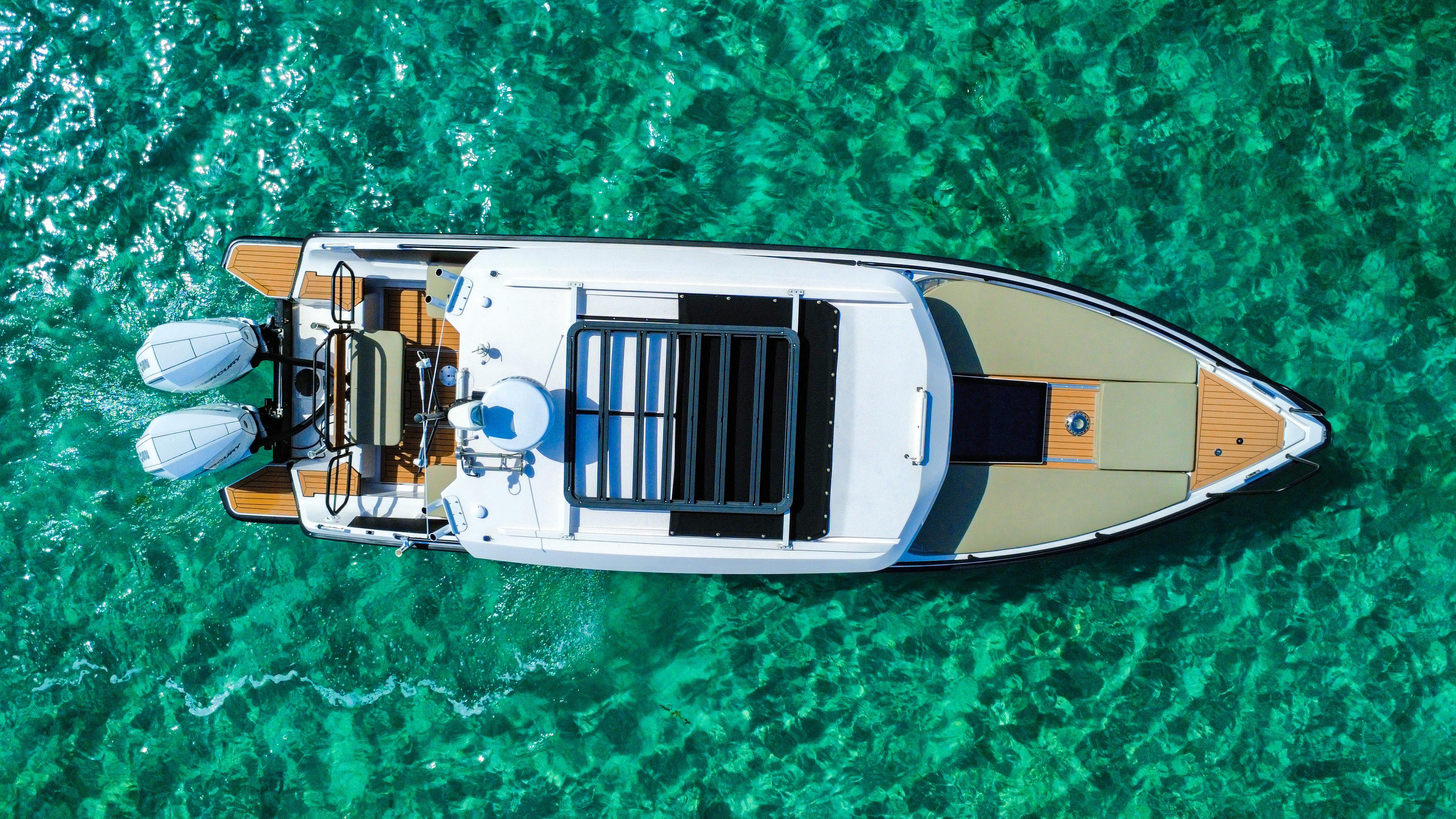 Picture of XO Boats 30.67 ft' XO Boats EXPLR 10S Plus 2024 XO Boats EXPLR 10S Plus on clear turquoise water, aerial view. 
