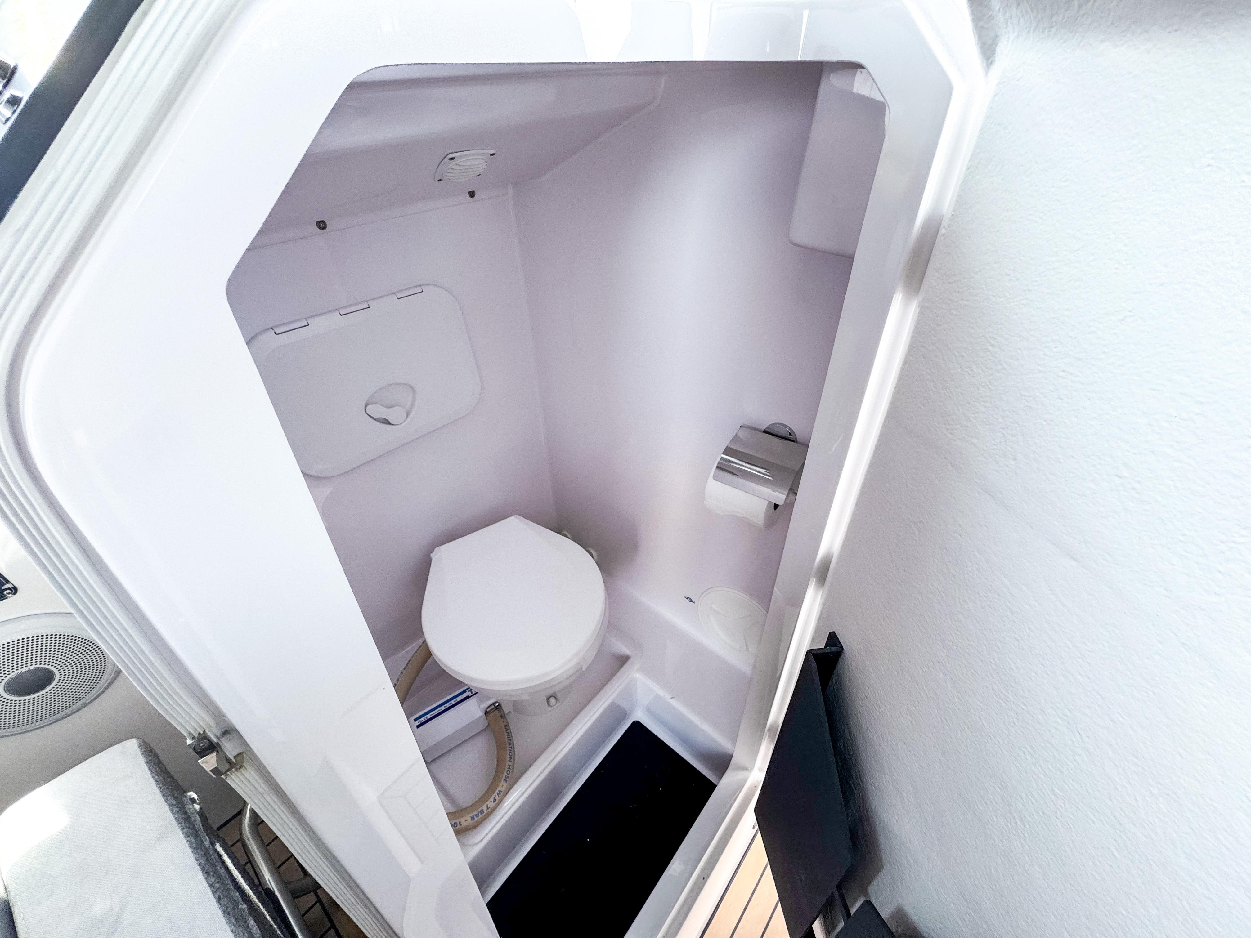 XO Boats-XO Boats EXPLR 10S Plus 2024 -FL-US-Compact bathroom in 2024 XO Boats EXPLR 10S Plus, featuring a modern toilet and sleek design.-9818089 | Thumbnail