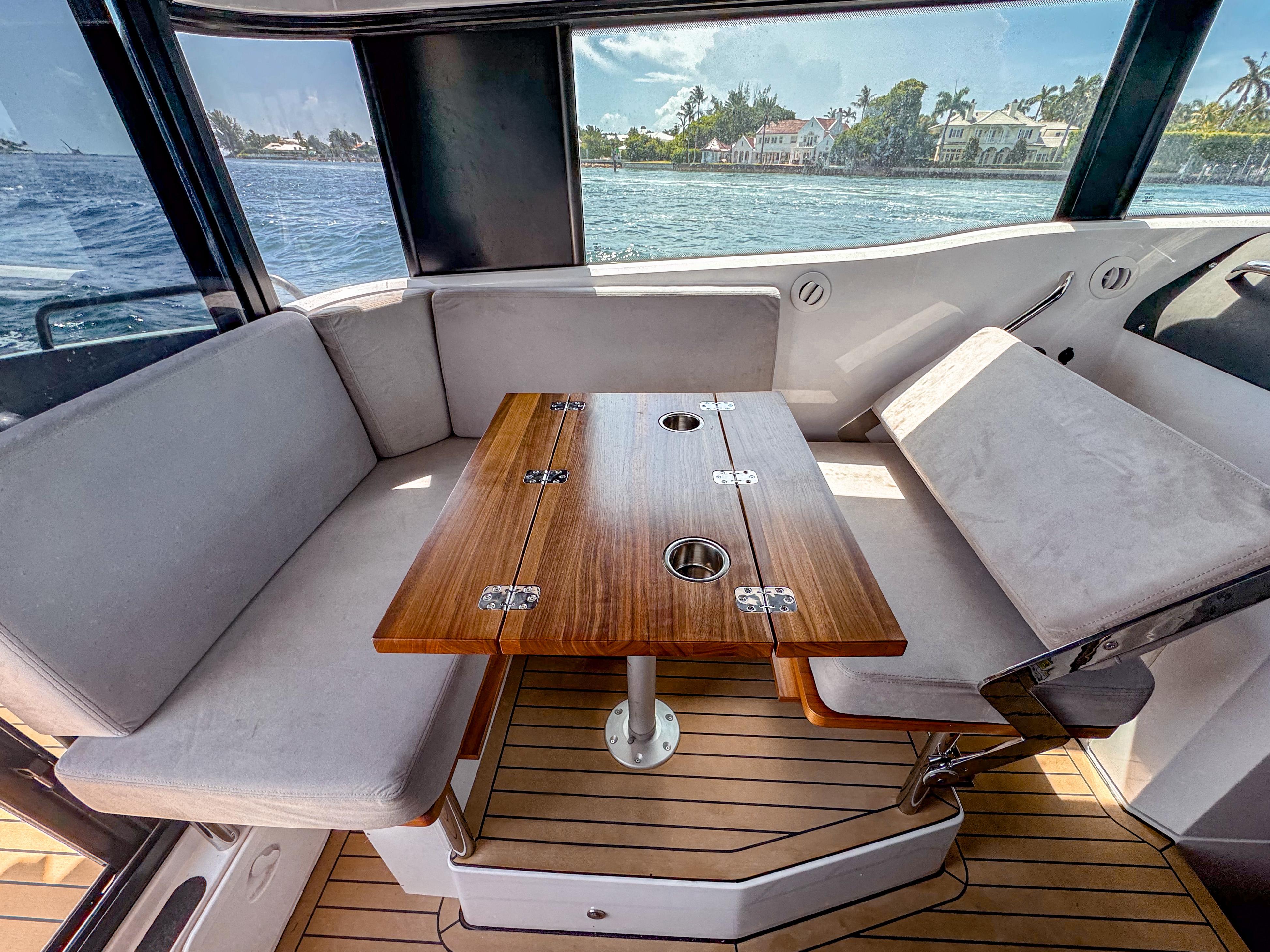 XO Boats-XO Boats EXPLR 10S Plus 2024 -FL-US-Interior of 2024 XO Boats EXPLR 10S Plus with wooden table and cushioned seating.-9818089 | Thumbnail