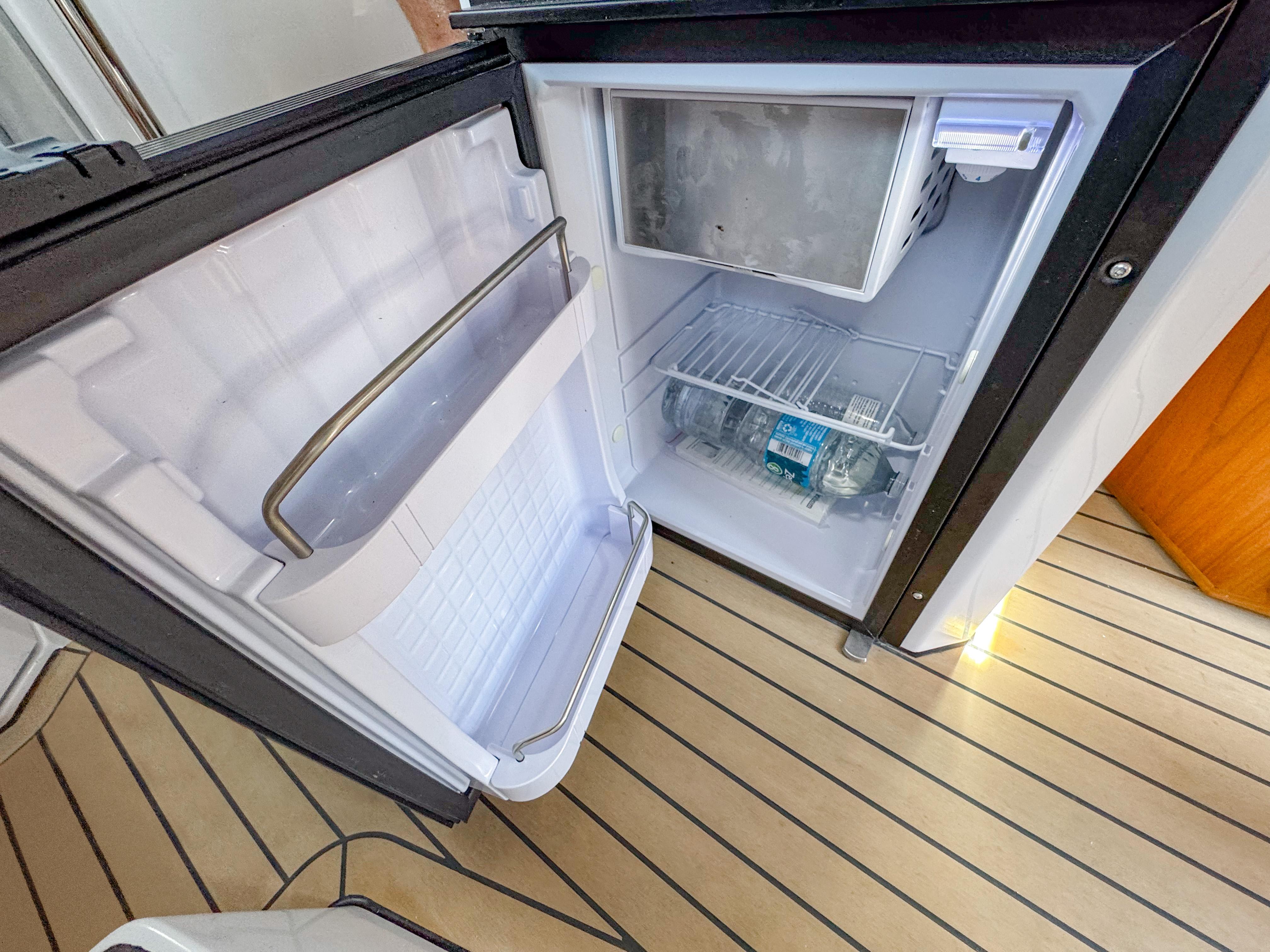 XO Boats-XO Boats EXPLR 10S Plus 2024 -FL-US-Open fridge on XO Boats EXPLR 10S Plus, 2024 model, with wooden flooring.-9818089 | Thumbnail