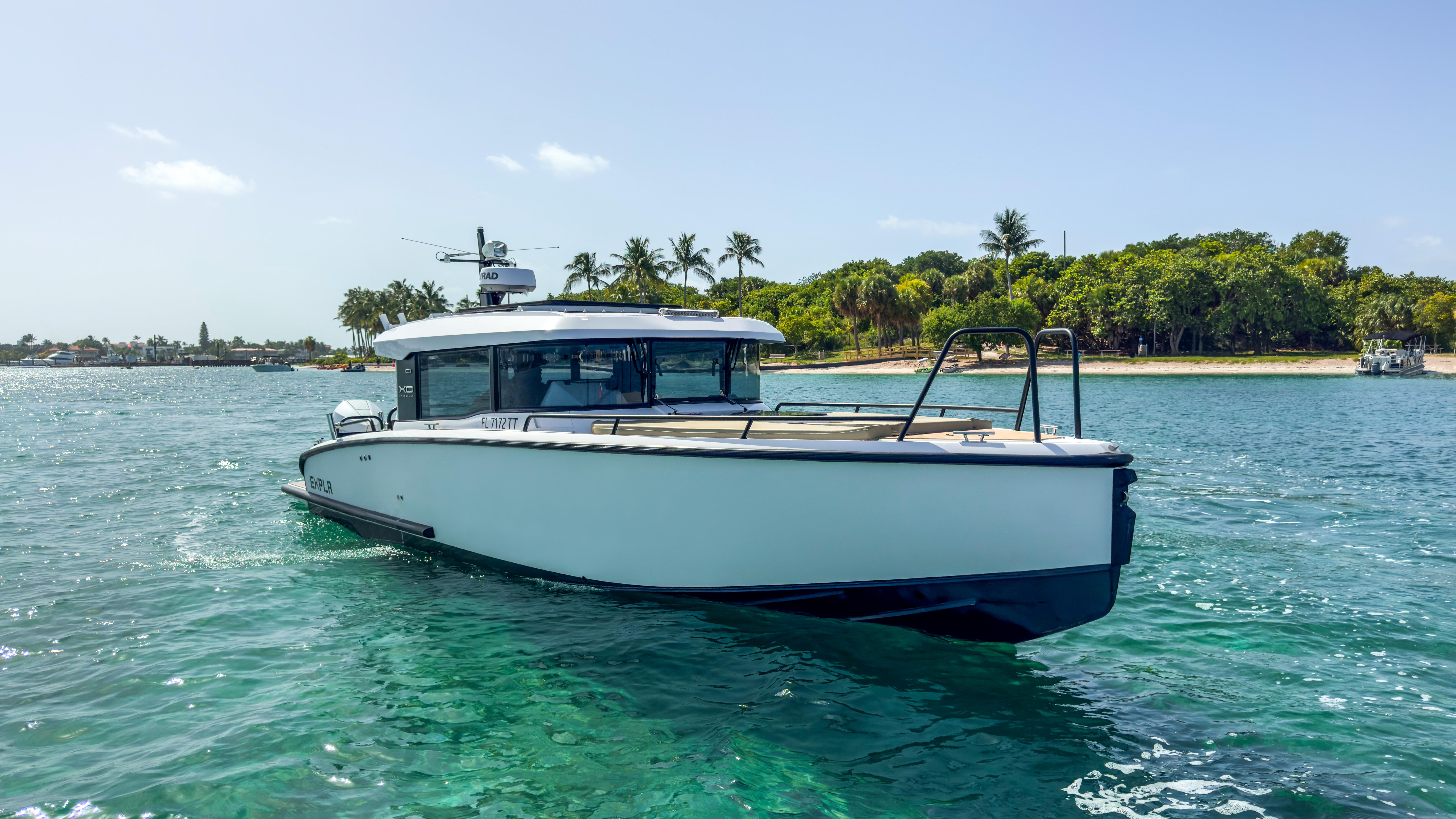 XO Boats-XO Boats EXPLR 10S Plus 2024 -FL-US-2024 XO Boats EXPLR 10S Plus cruising near a tropical shoreline.-9818089 | Thumbnail