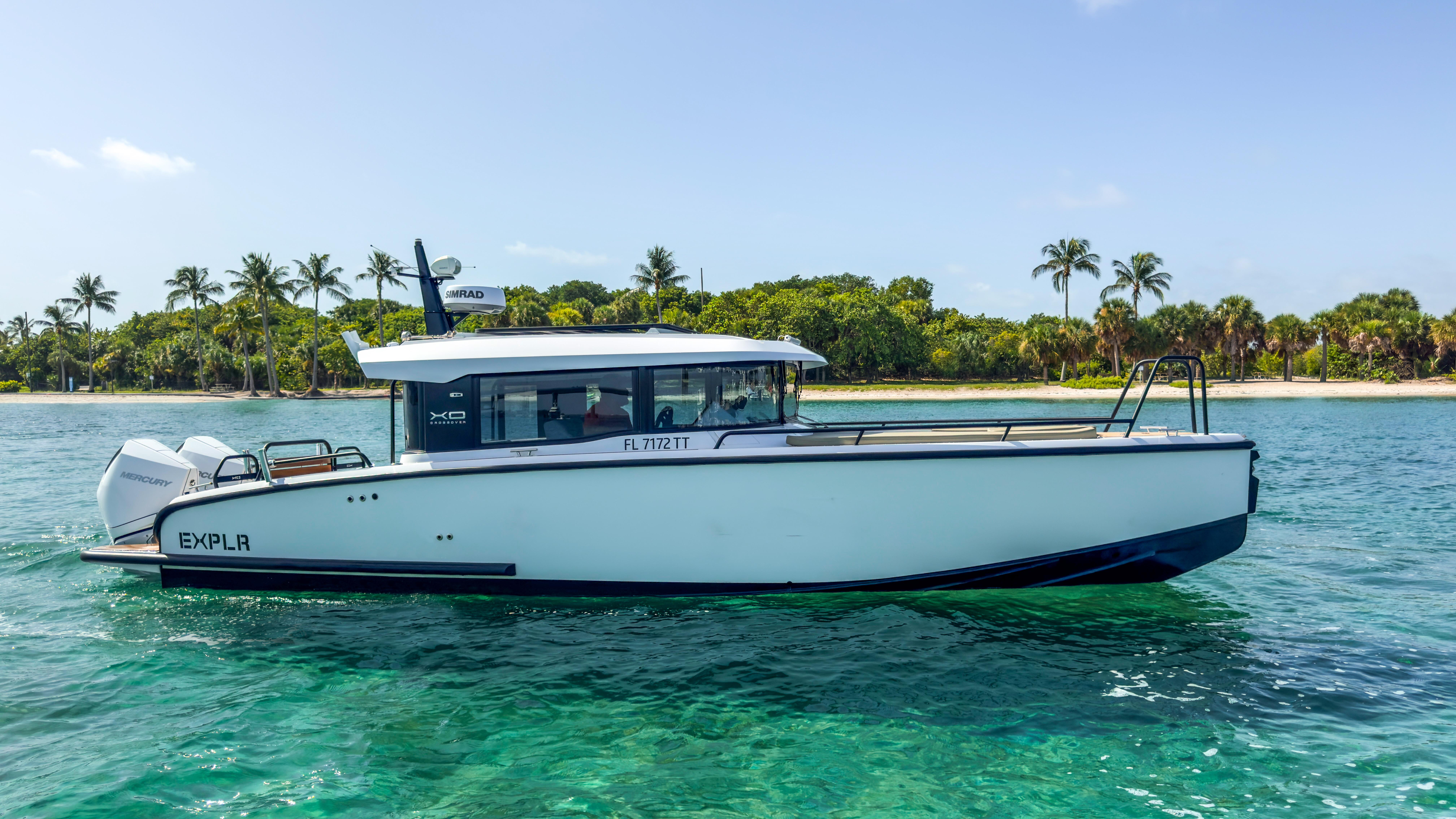 Picture of XO Boats 30.67 ft' XO Boats EXPLR 10S Plus 2024 XO Boats EXPLR 10S Plus cruising near a tropical shoreline with palm trees. 