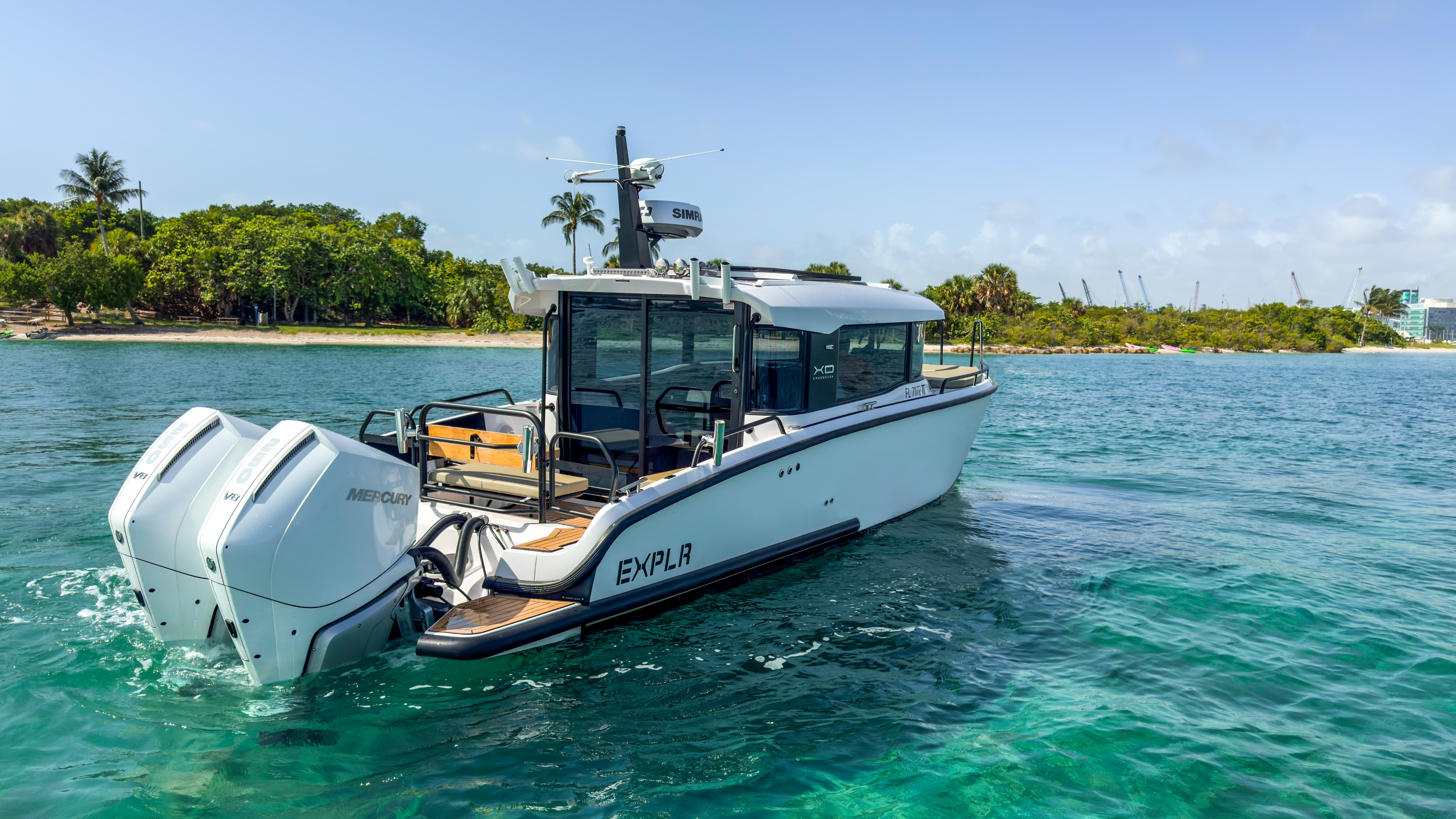 XO Boats-XO Boats EXPLR 10S Plus 2024 -FL-US-2024 XO Boats EXPLR 10S Plus cruising on clear blue water near a tropical shoreline.-9818089 | Thumbnail