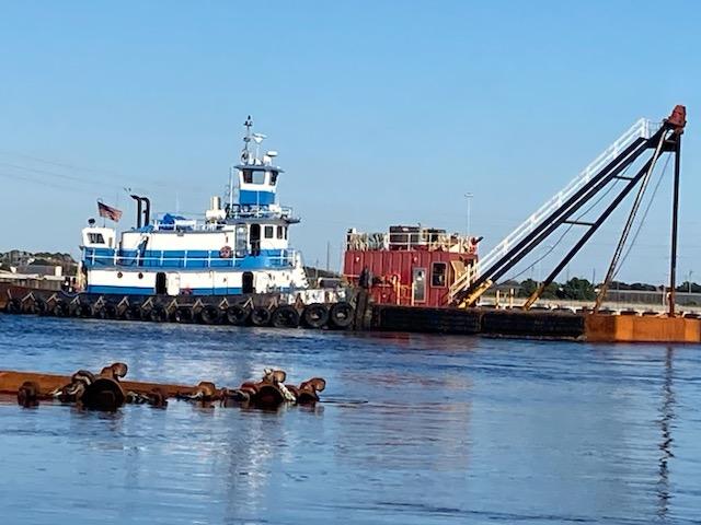 Commercial-Model Bow Tug 1961 -FL-US-A 1961 Commercial Model Bow Tugboat on a calm river, with a barge in the background.-9787034 | Thumbnail
