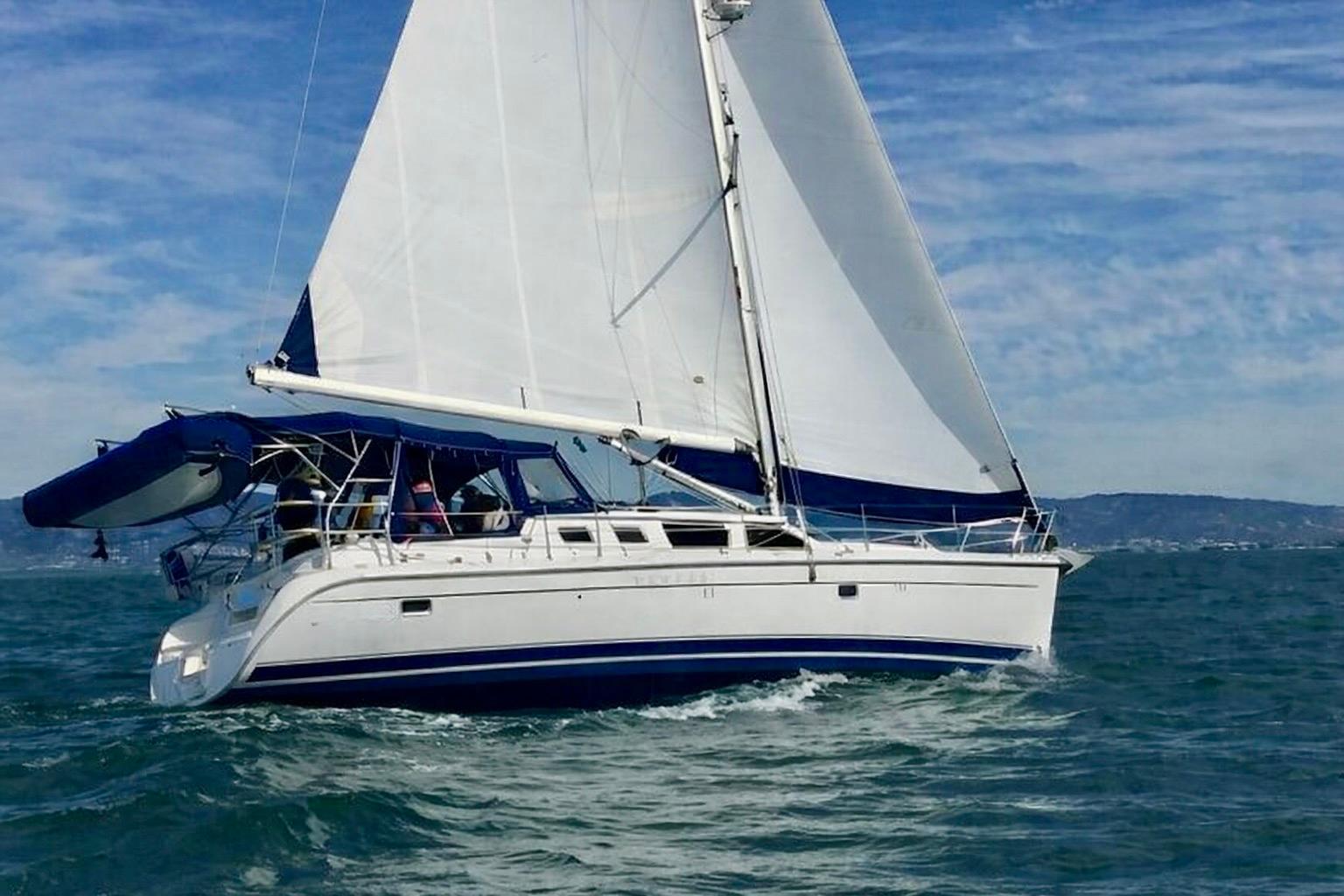 2007 Hunter 44 Deck Salon sailing on open water under clear skies.