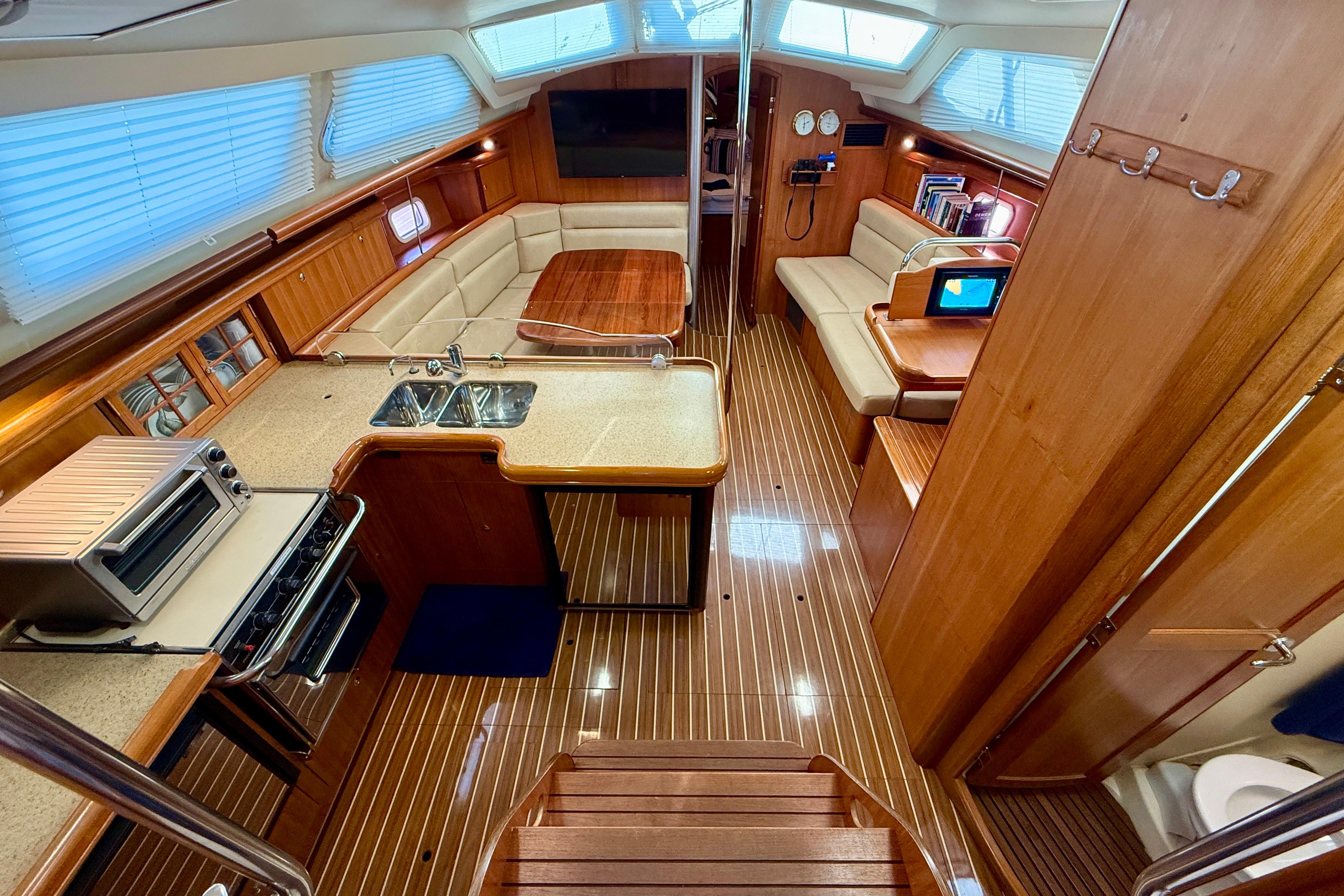 Luxurious interior of 2007 Hunter 44 Deck Salon yacht with modern kitchen and seating area.