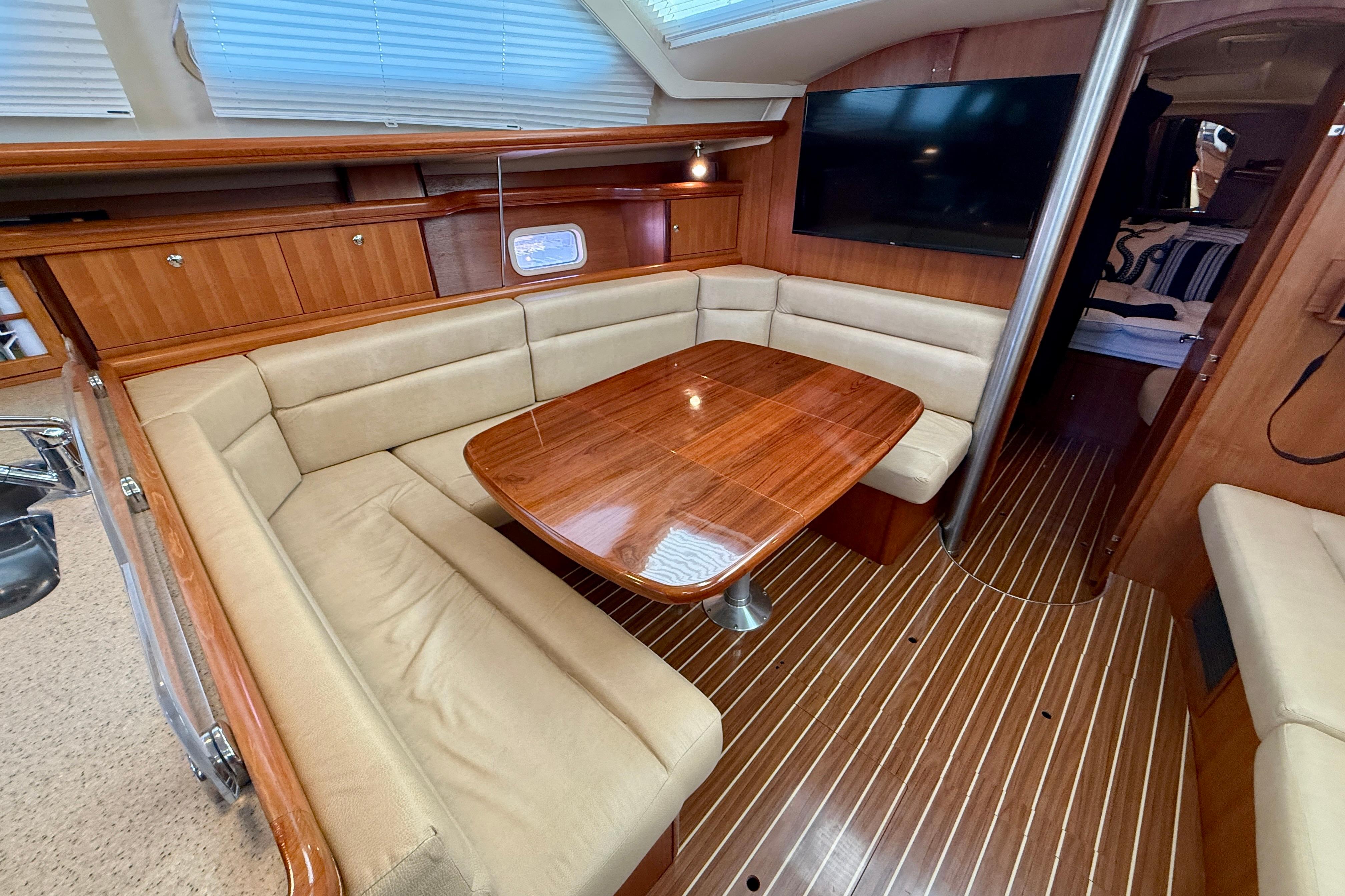 Luxurious interior of 2007 Hunter 44 Deck Salon with wood finish and plush seating.