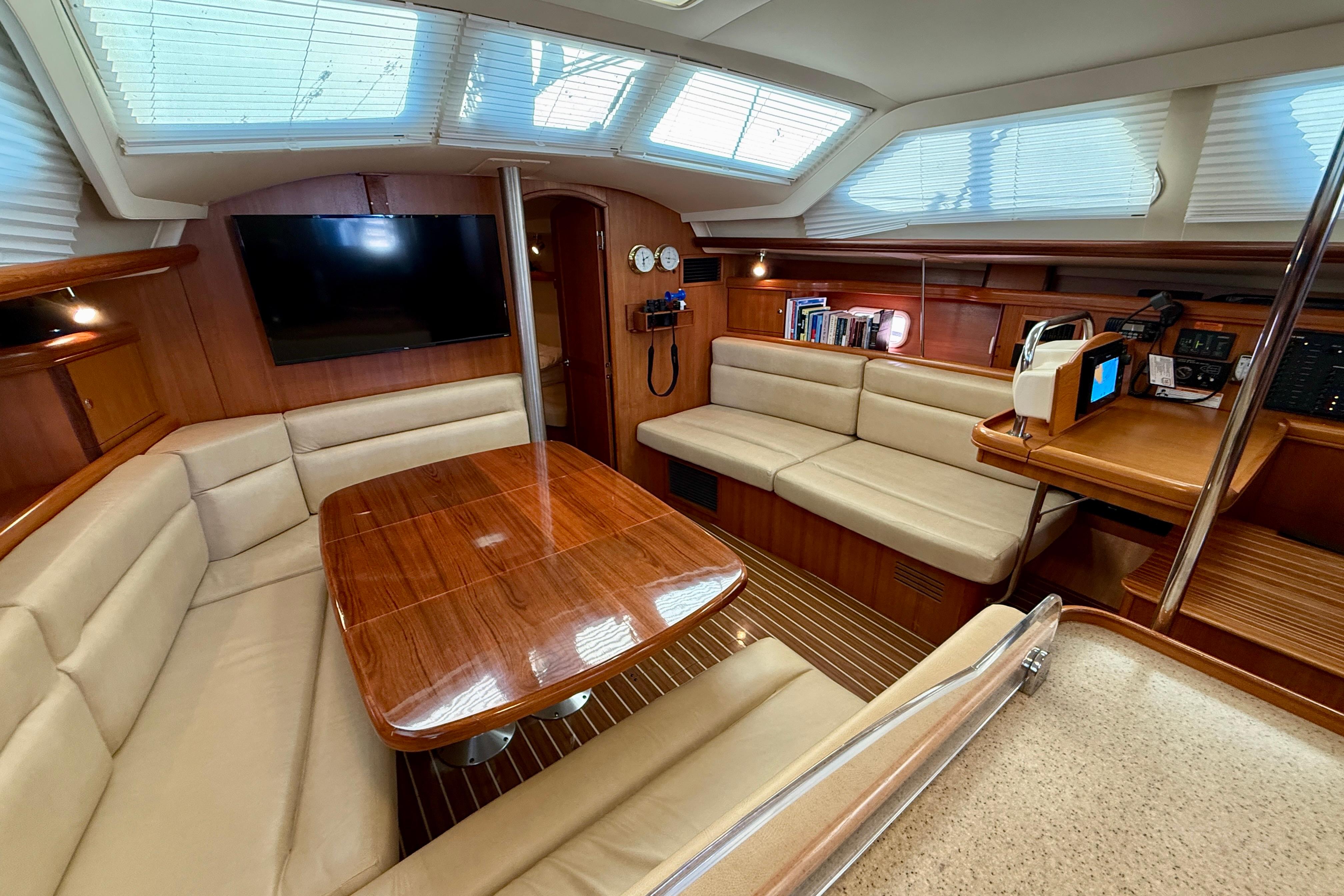 Luxurious interior of 2007 Hunter 44 Deck Salon with plush seating and wooden finishes.