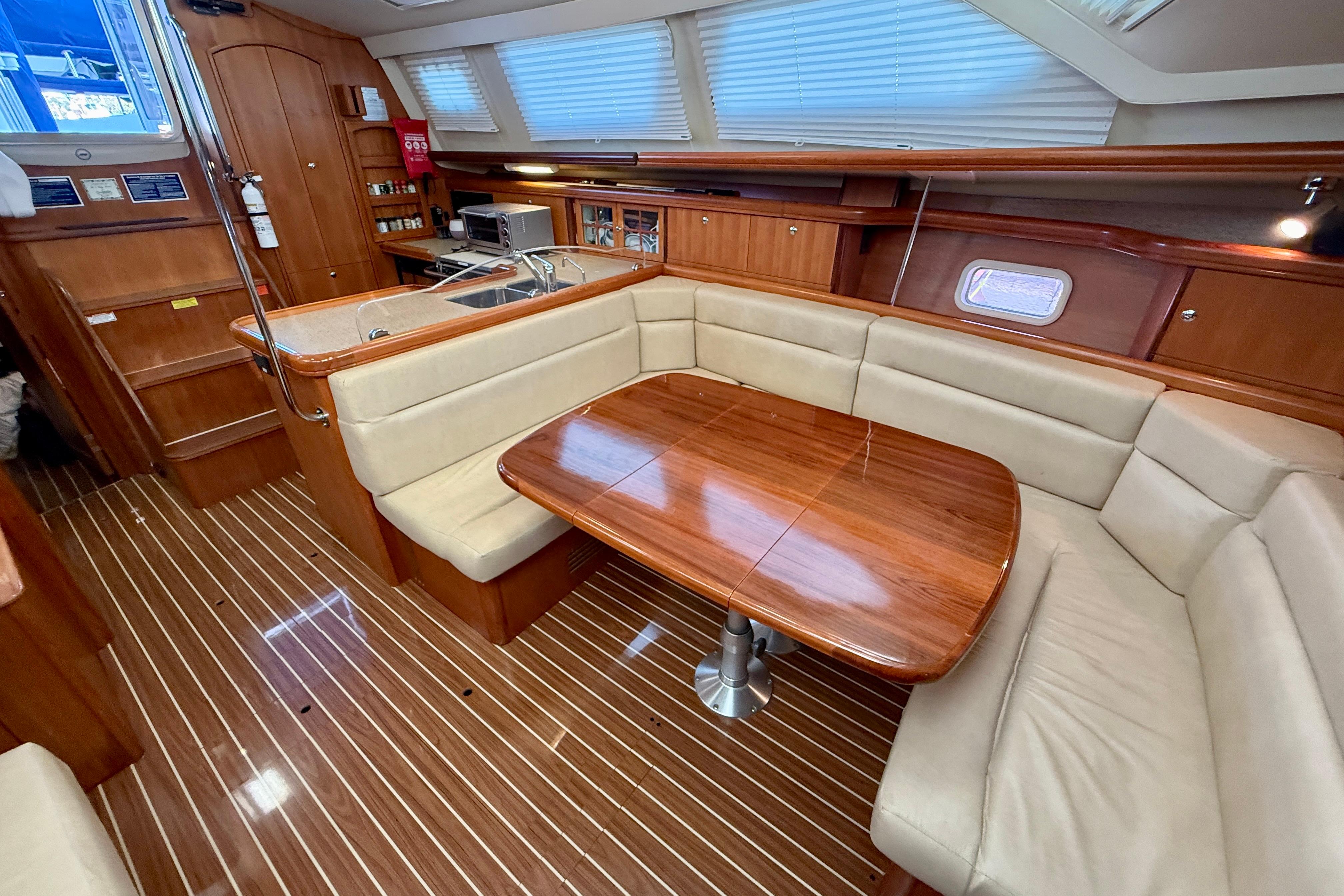 Luxurious interior of 2007 Hunter 44 Deck Salon with elegant wood finishes and spacious seating.