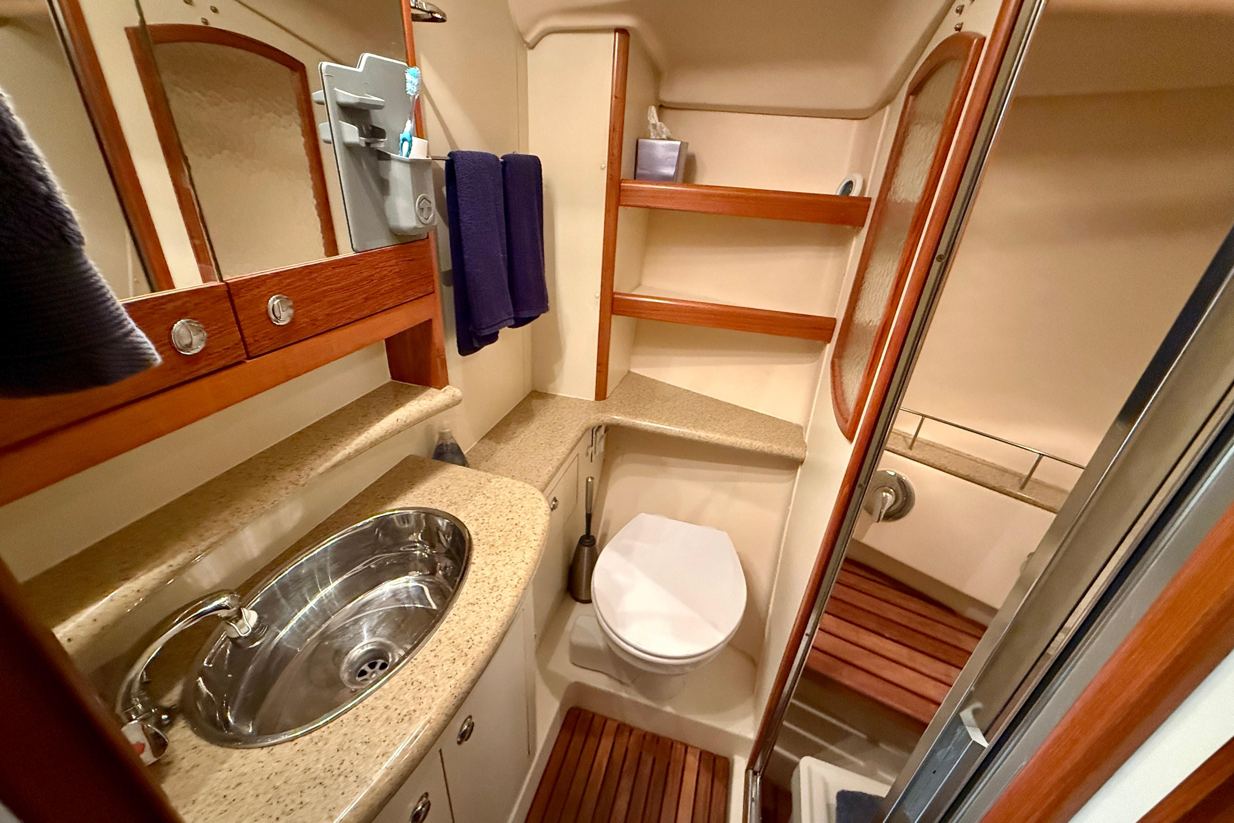 Luxurious bathroom in 2007 Hunter 44 Deck Salon yacht with modern fixtures and wooden accents.