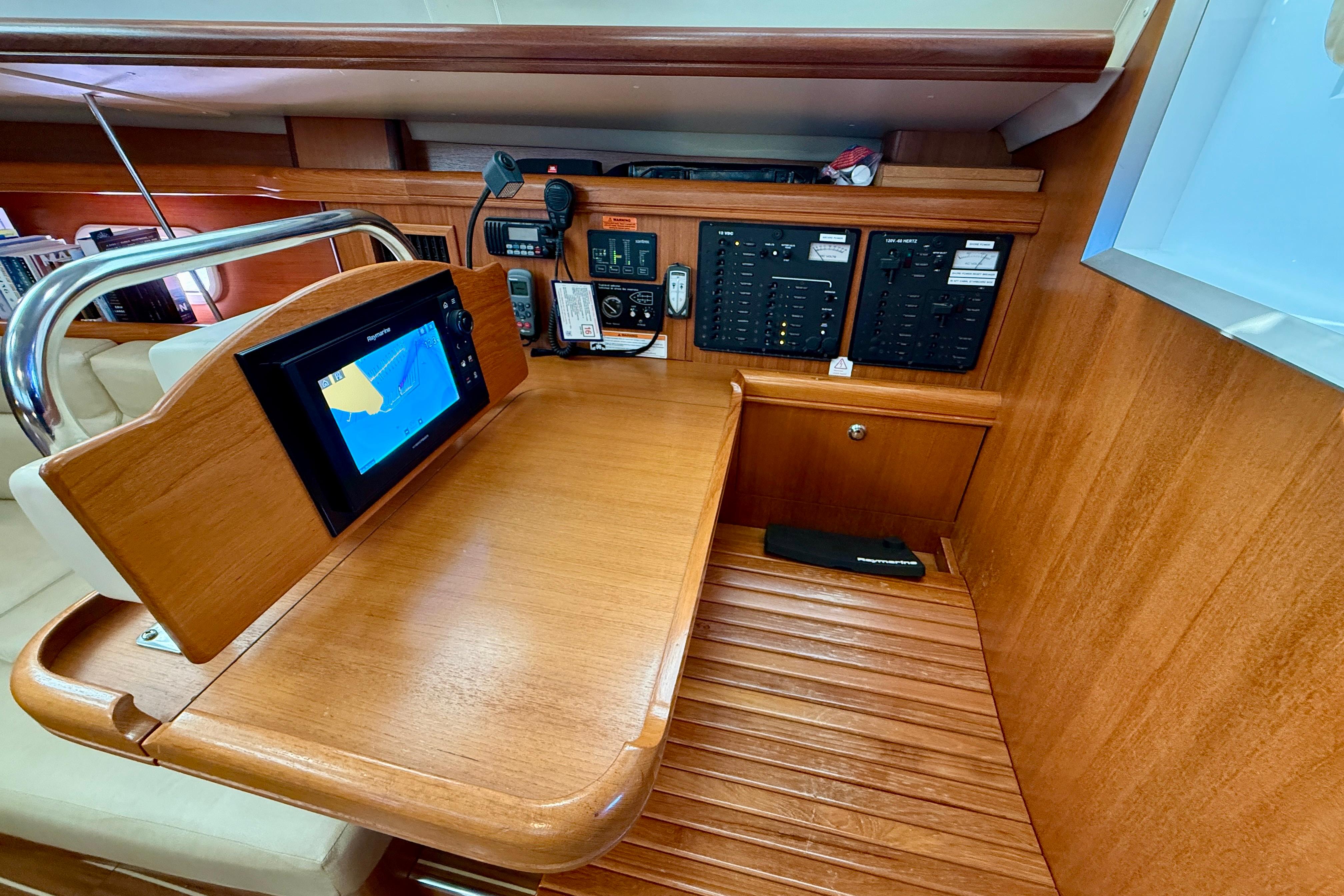 Navigation station of 2007 Hunter 44 Deck Salon with control panels and chart plotter.