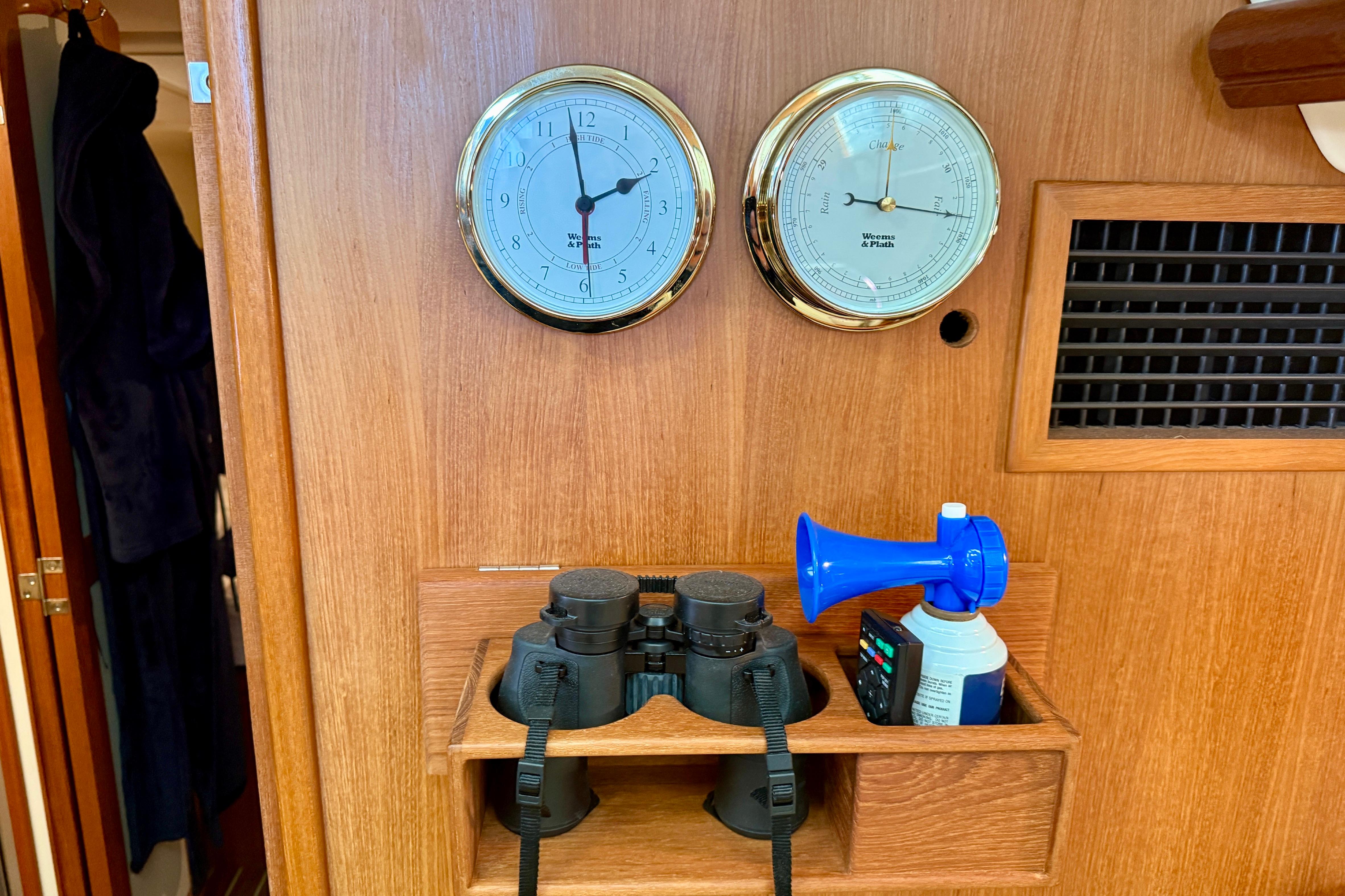 Interior of 2007 Hunter 44 Deck Salon with clock, barometer, binoculars, and air horn.