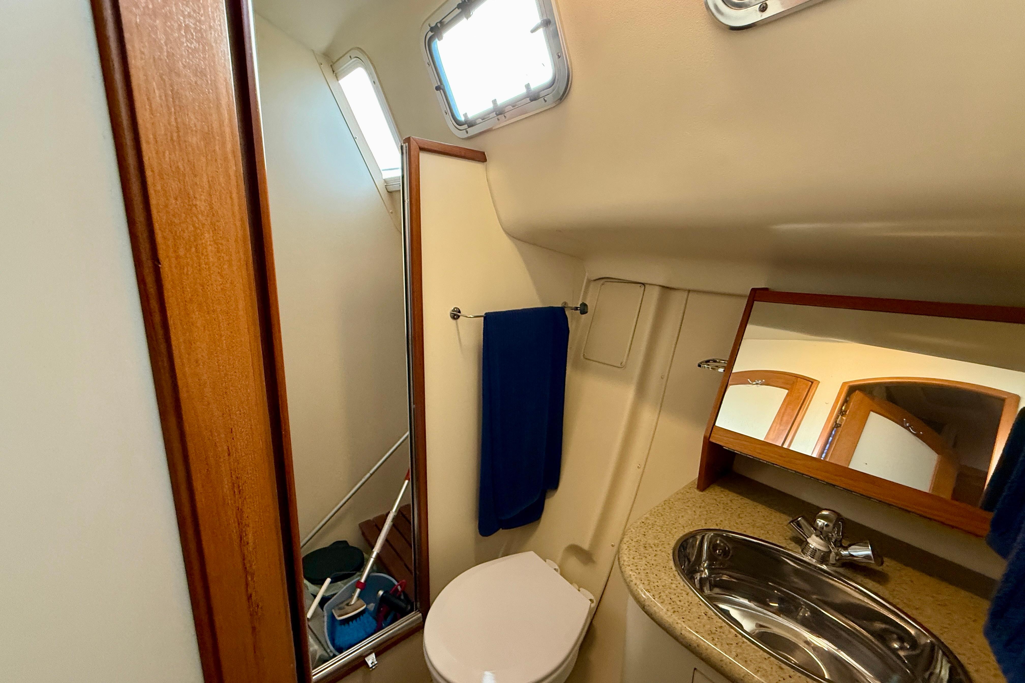 Bathroom interior of 2007 Hunter 44 Deck Salon yacht with sink and mirror.