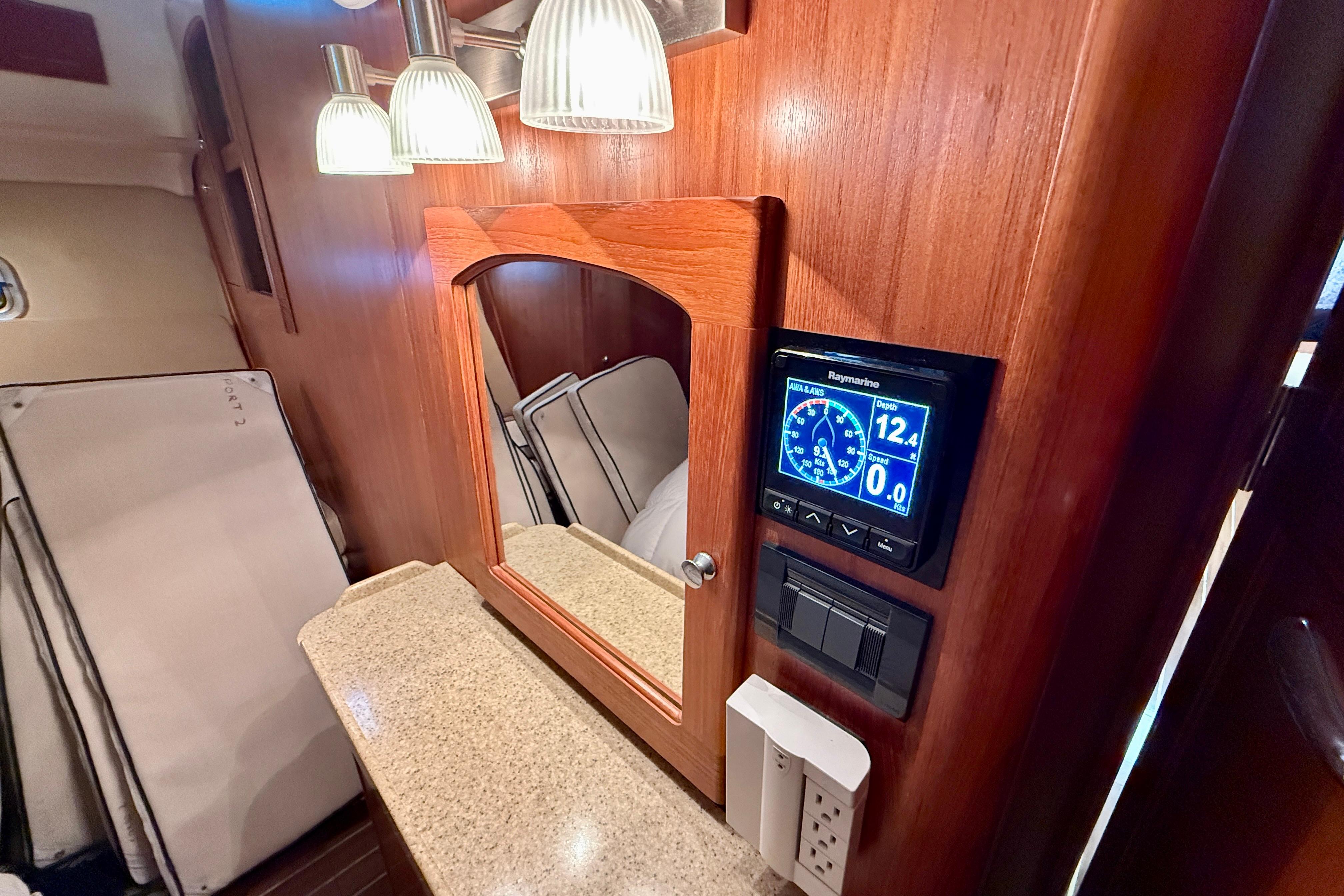 Interior of 2007 Hunter 44 Deck Salon with wood paneling and navigation display.