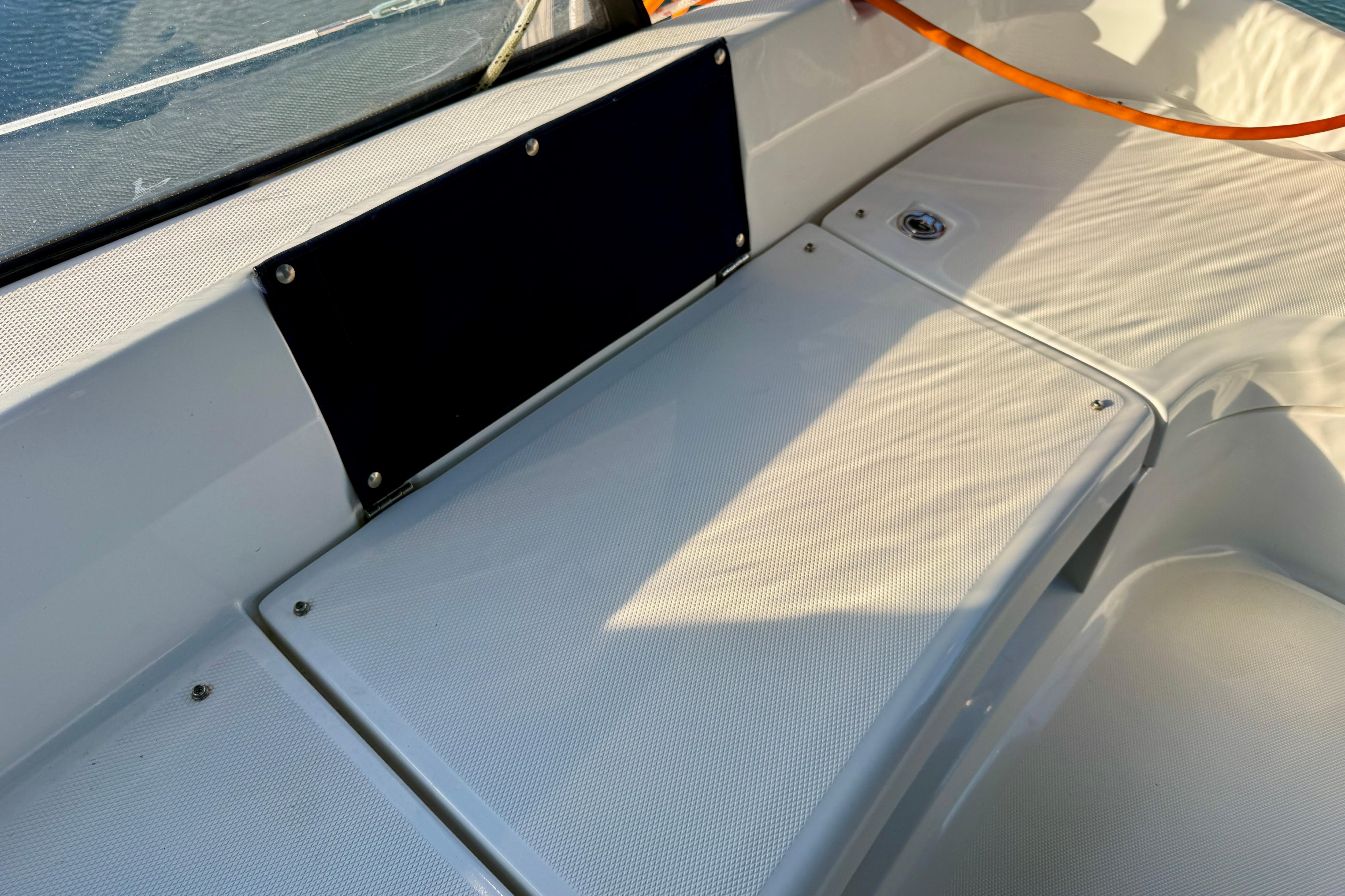 2007 Hunter 44 Deck Salon cockpit area with white seating and black panel.