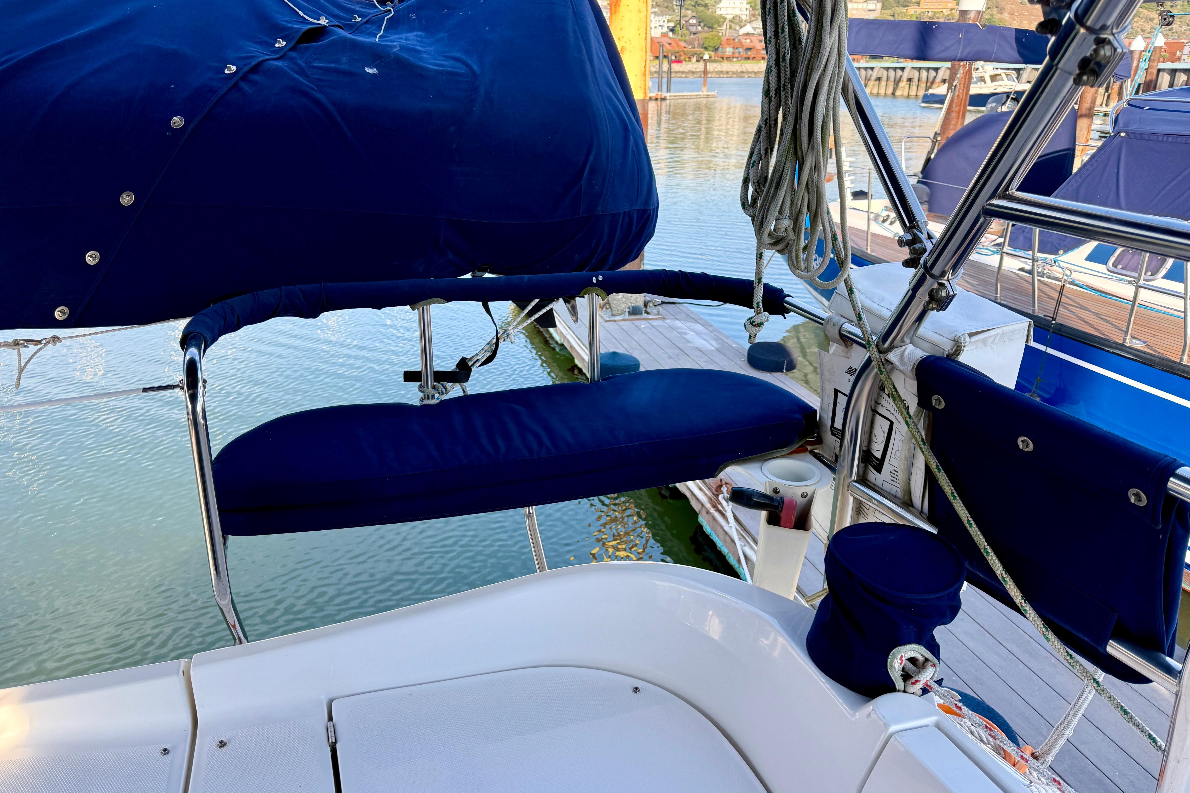 2007 Hunter 44 Deck Salon sailboat cockpit with blue seating and marina view.