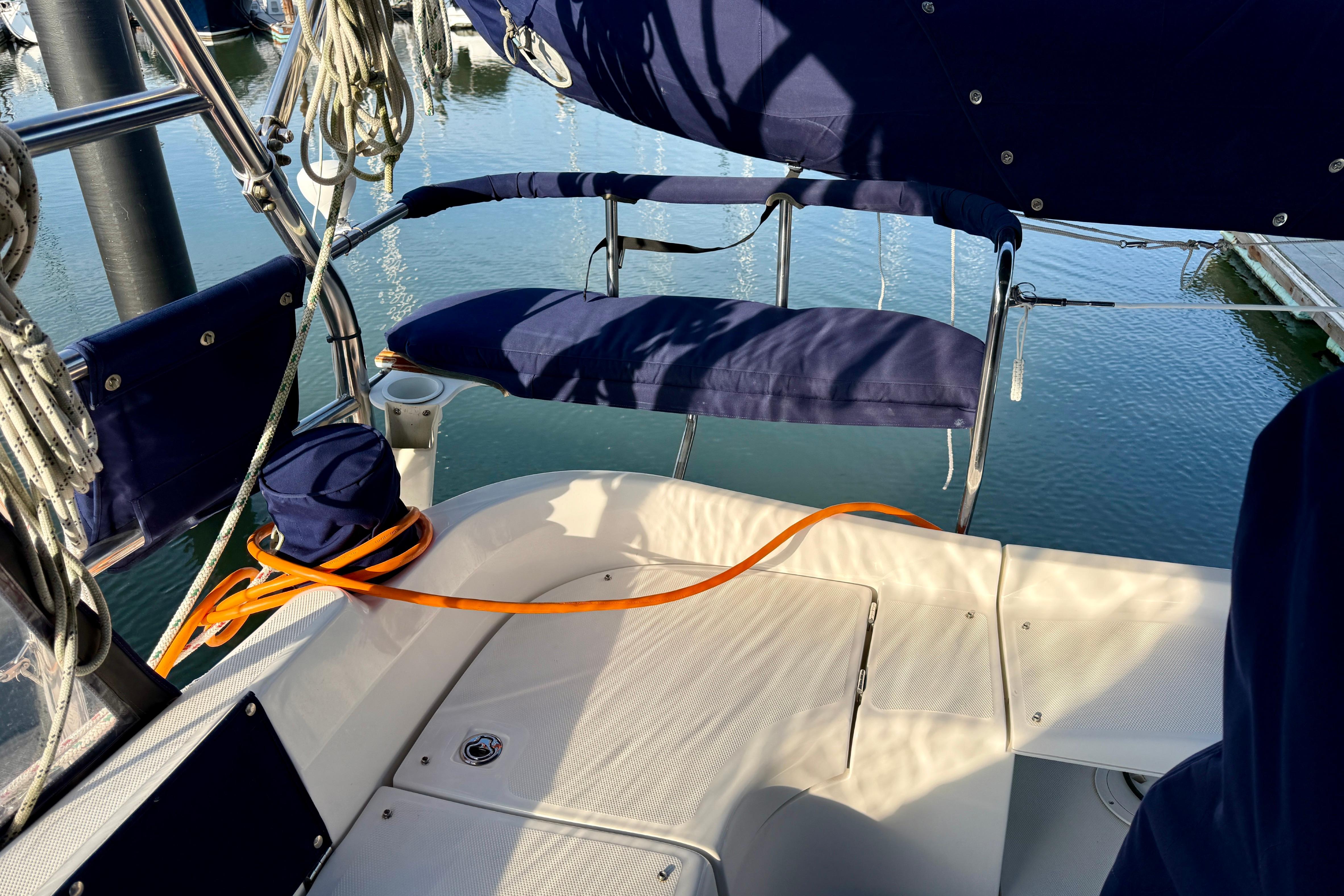 2007 Hunter 44 Deck Salon sailboat cockpit with blue seating and orange rope.