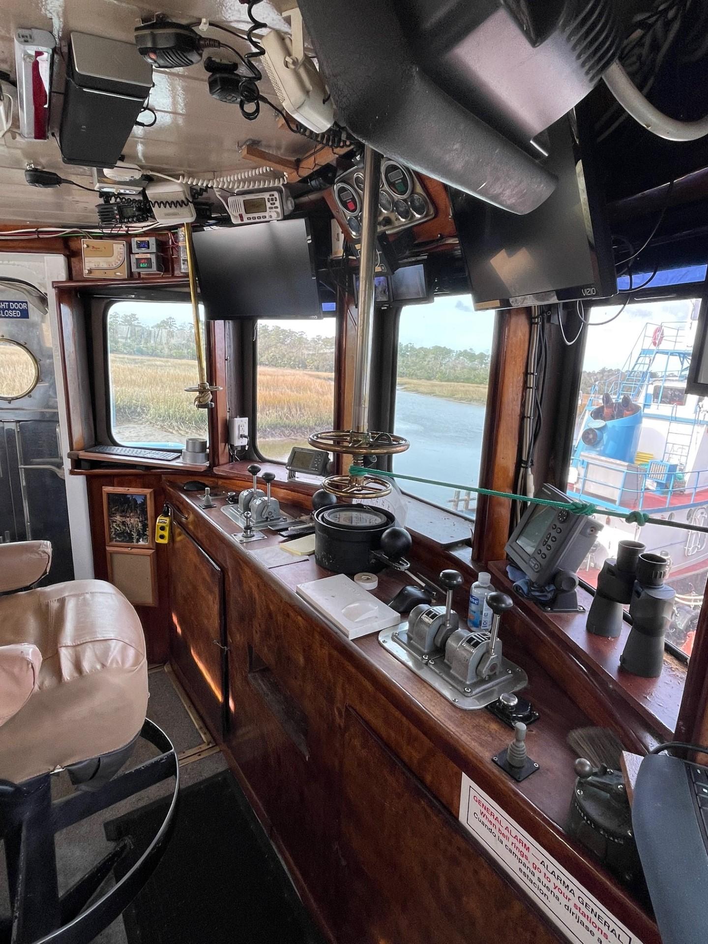 Commercial-Model Bow Tug 1961 -FL-US-Interior of a 1961 Commercial Model Bow Tugboat with navigation equipment and river view.-9787034 | Thumbnail