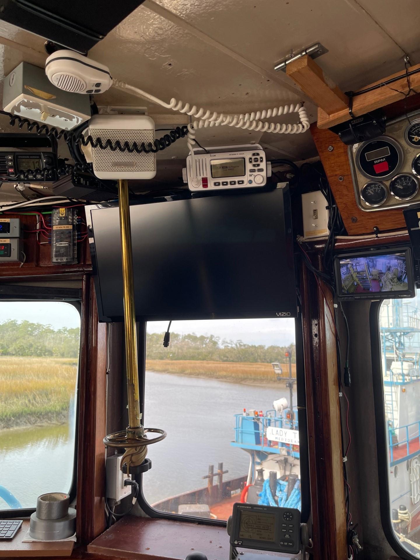 Commercial-Model Bow Tug 1961 -FL-US-Interior of a 1961 Commercial Model Bow Tugboat, showcasing navigation equipment and river view.-9787034 | Thumbnail