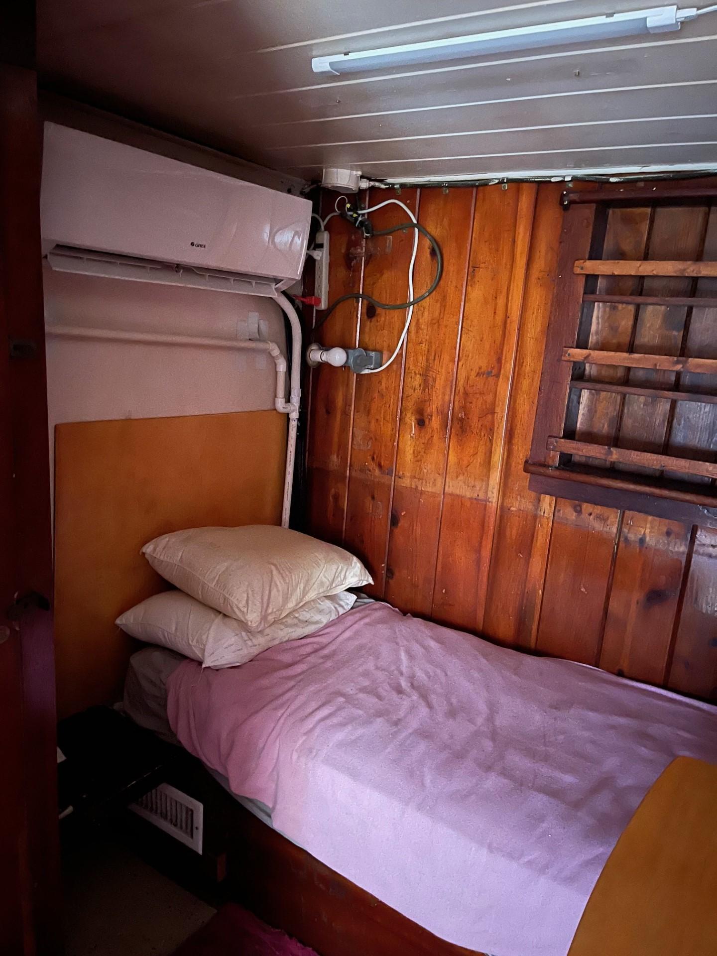 Commercial-Model Bow Tug 1961 -FL-US-Cozy wooden cabin interior on a 1961 Commercial Model Bow Tug, featuring a single bed and air conditioning.-9787034 | Thumbnail