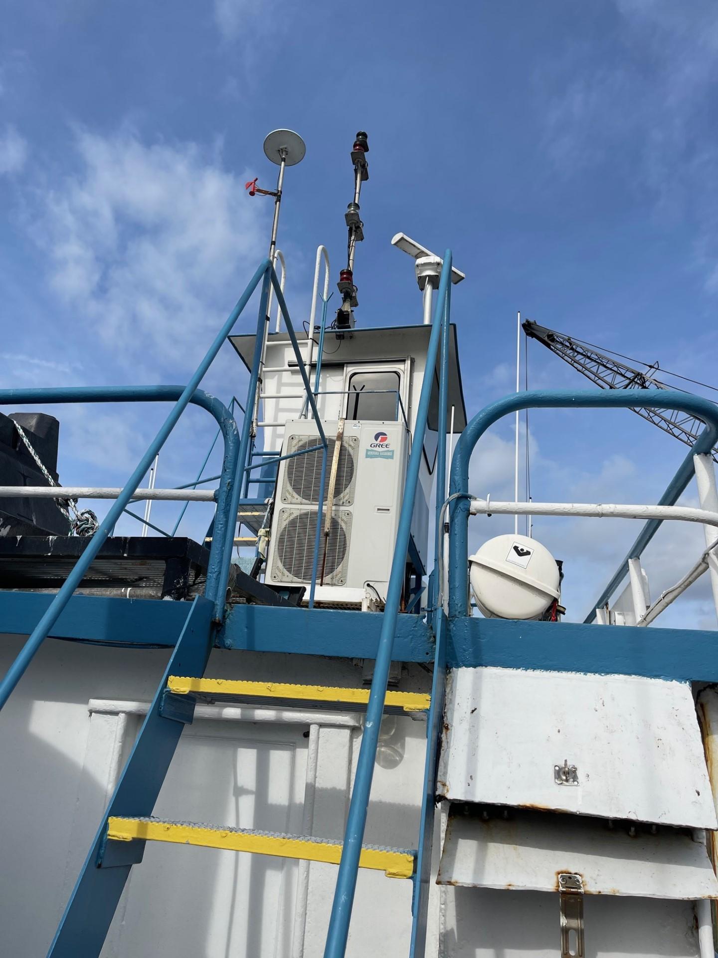 Commercial-Model Bow Tug 1961 -FL-US-1961 Commercial Model Bow Tug with blue railings and equipment against a clear sky.-9787034 | Thumbnail
